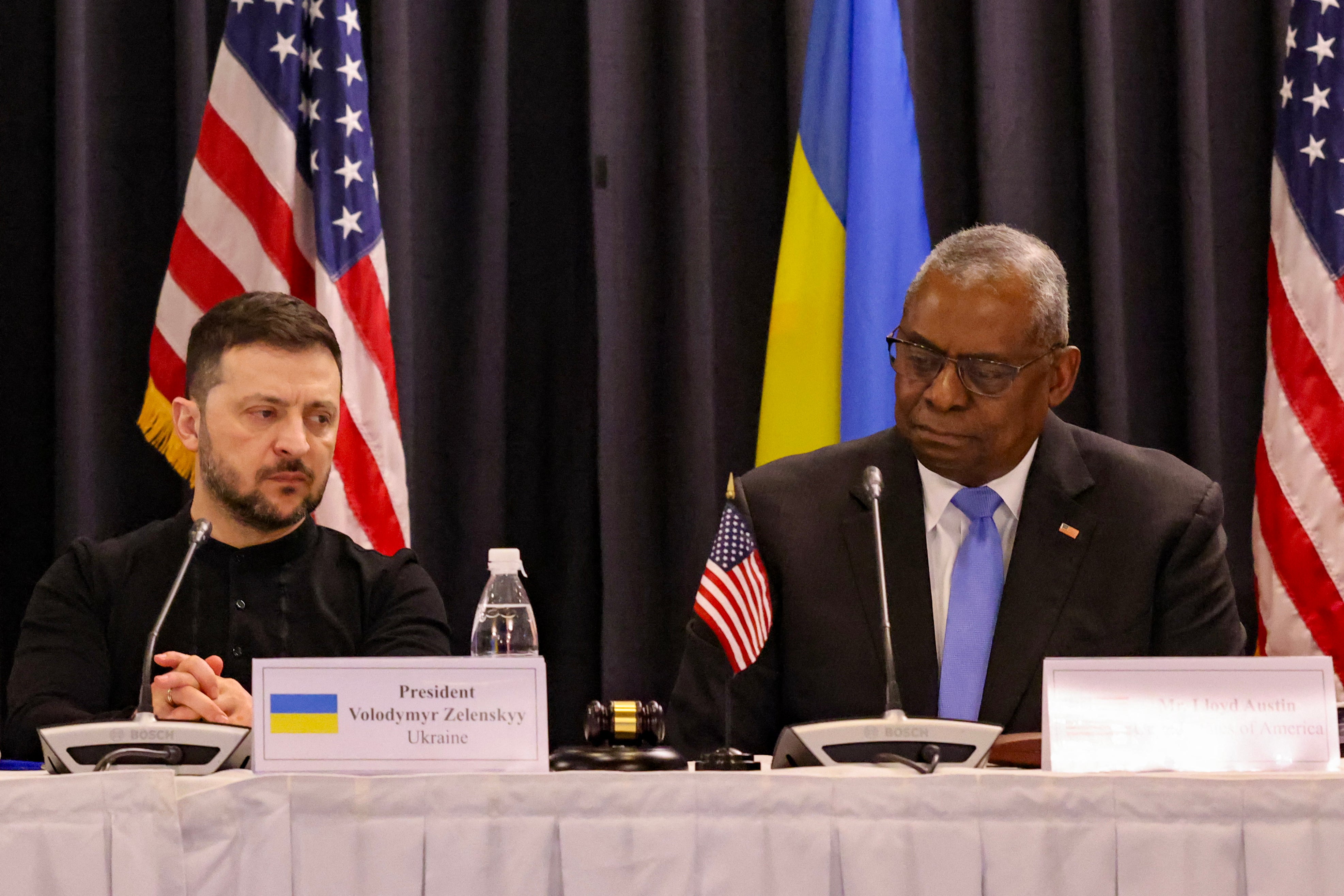 Volodymyr Zelensky and US secretary of defence Lloyd Austin react during the opening of the Ukraine Defense Contact Group meeting at Ramstein Air Base, Germany