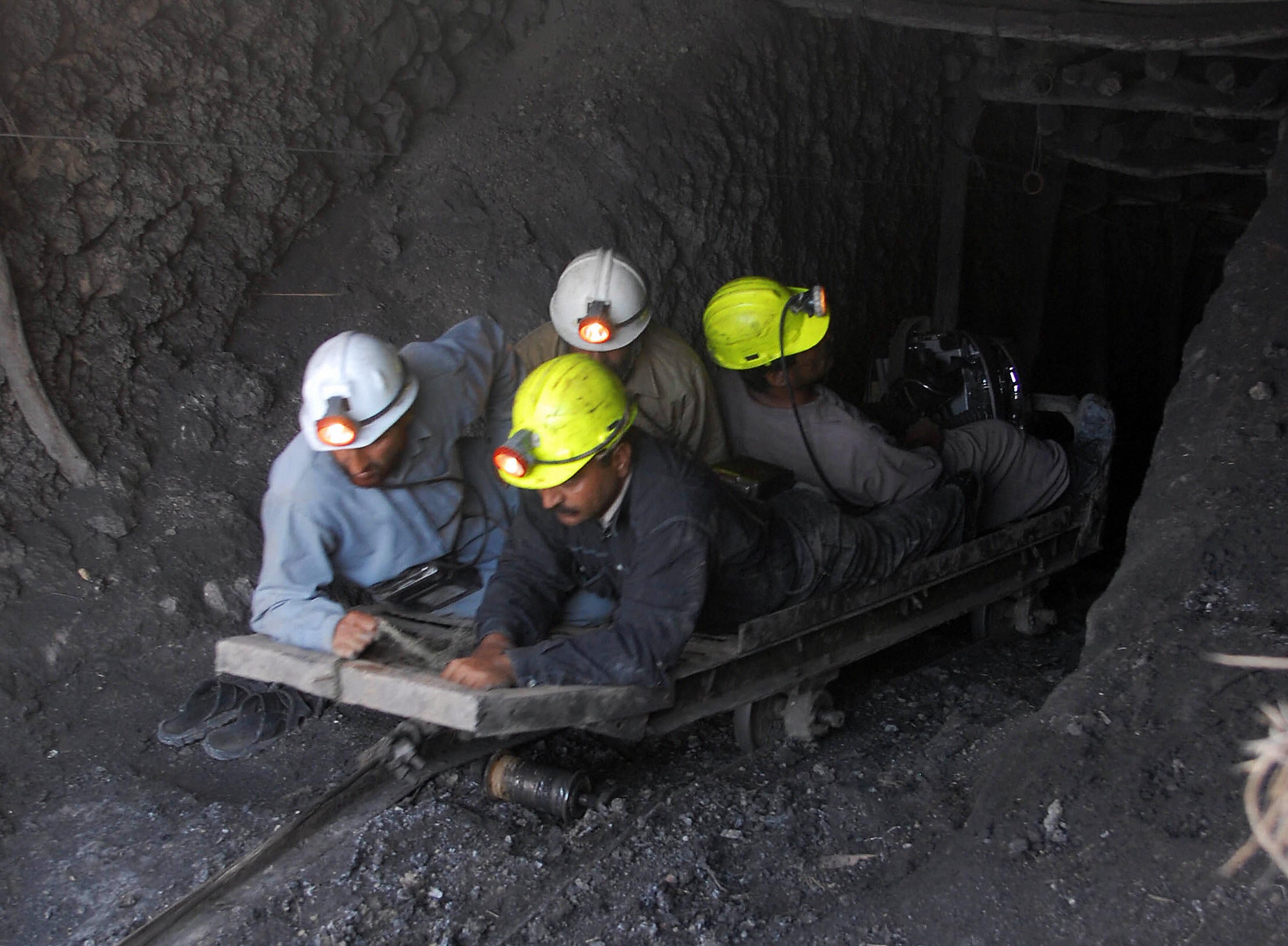 File. Miners join a search for fellow workers at a coal mine following a gas explosion