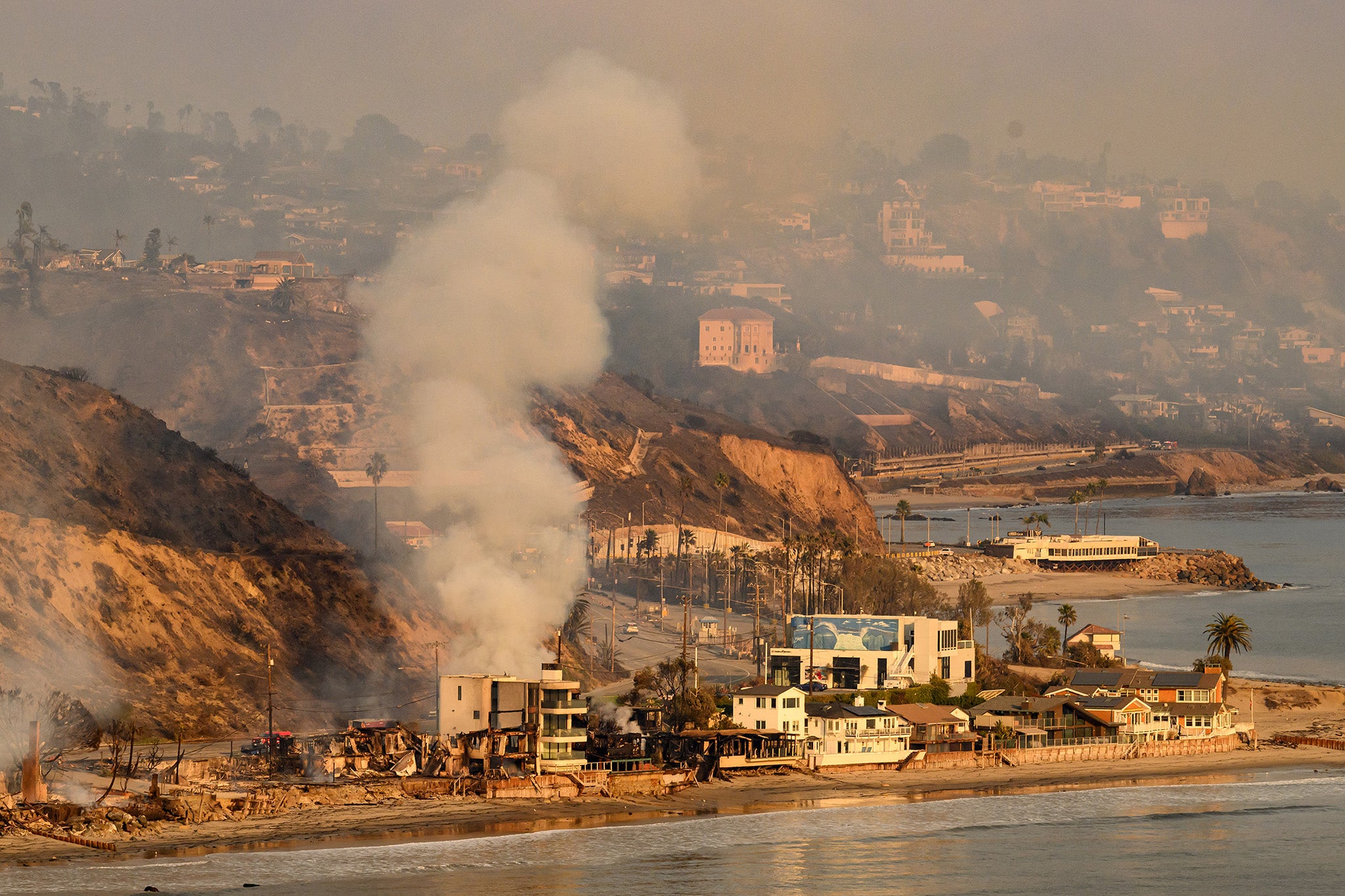 A home burns on California’s Pacific Coast Highway as wildfires ravage the area. The new state rule come after thousands of homes were burned in Los Angeles.