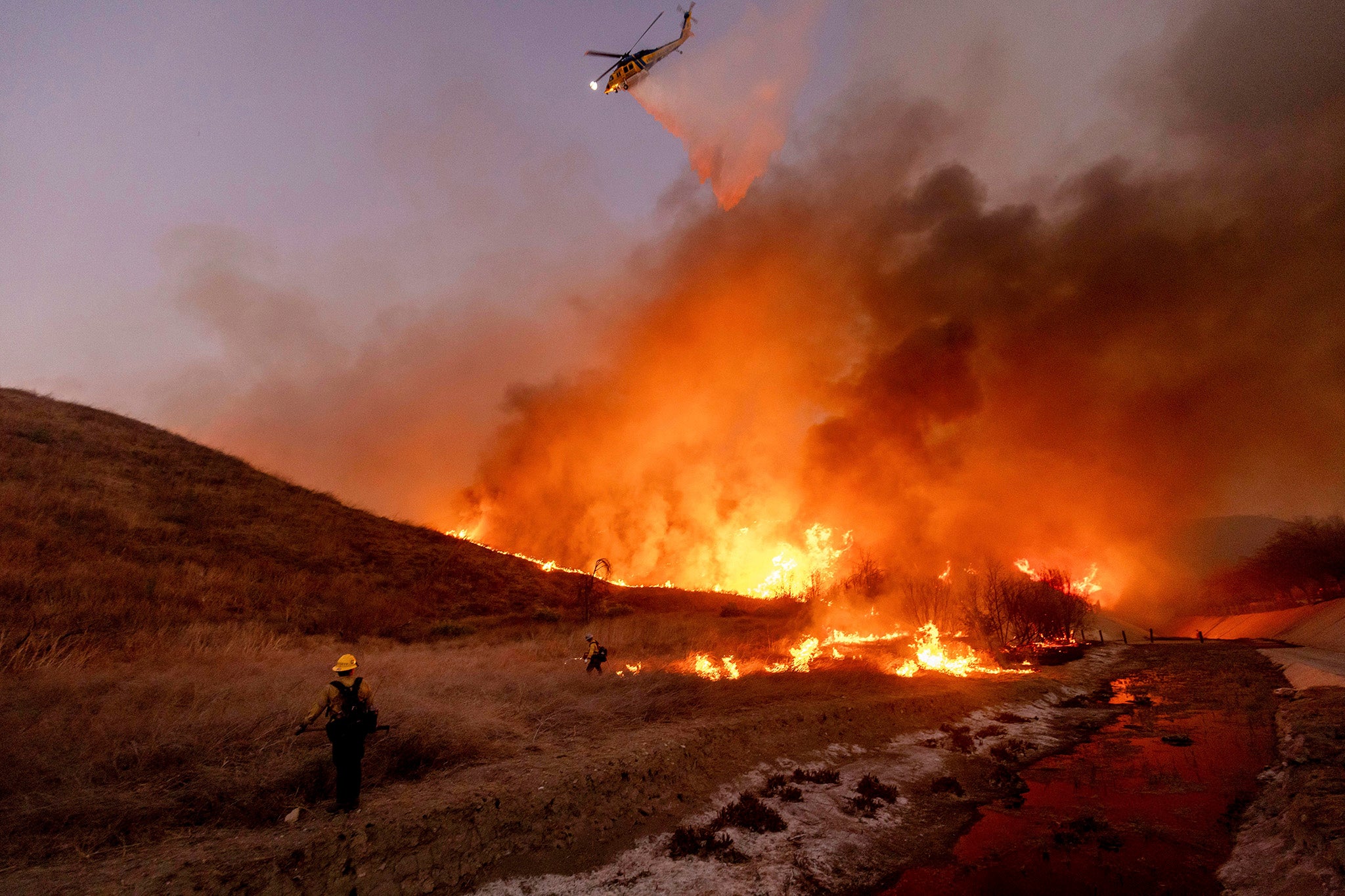 Fire crews battle the Kenneth Fire in the West Hills section of Los Angeles, Thursday