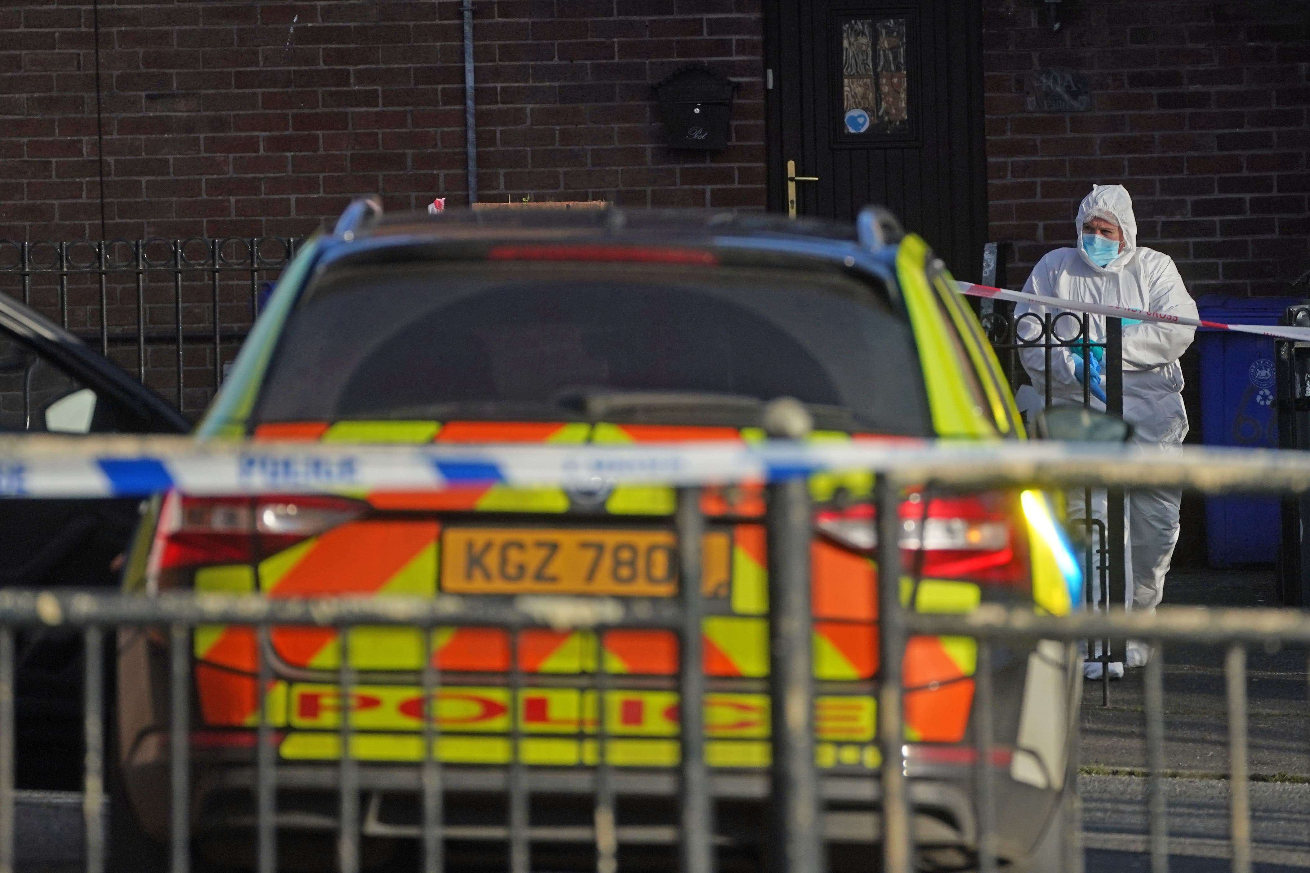 A police forensic officer at the scene in the Greenan area of west Belfast where a man was shot dead (Brian Lawless/PA)