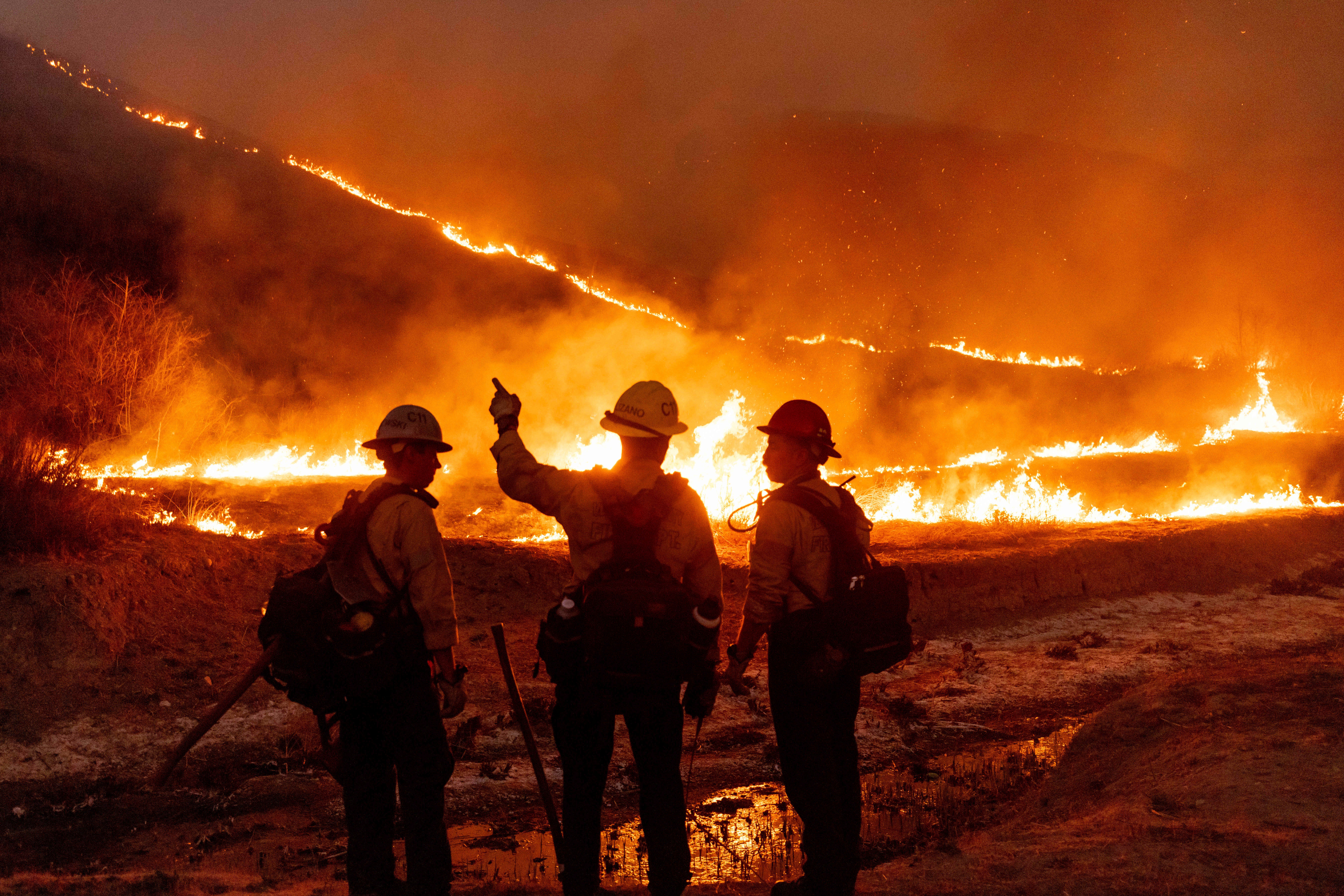 Fire crews battle the Kenneth Fire in the West Hills area of Los Angeles. In California, a new rule says eligible home insurance policy owners cannot be dropped or issued a non-renewal until January 2026