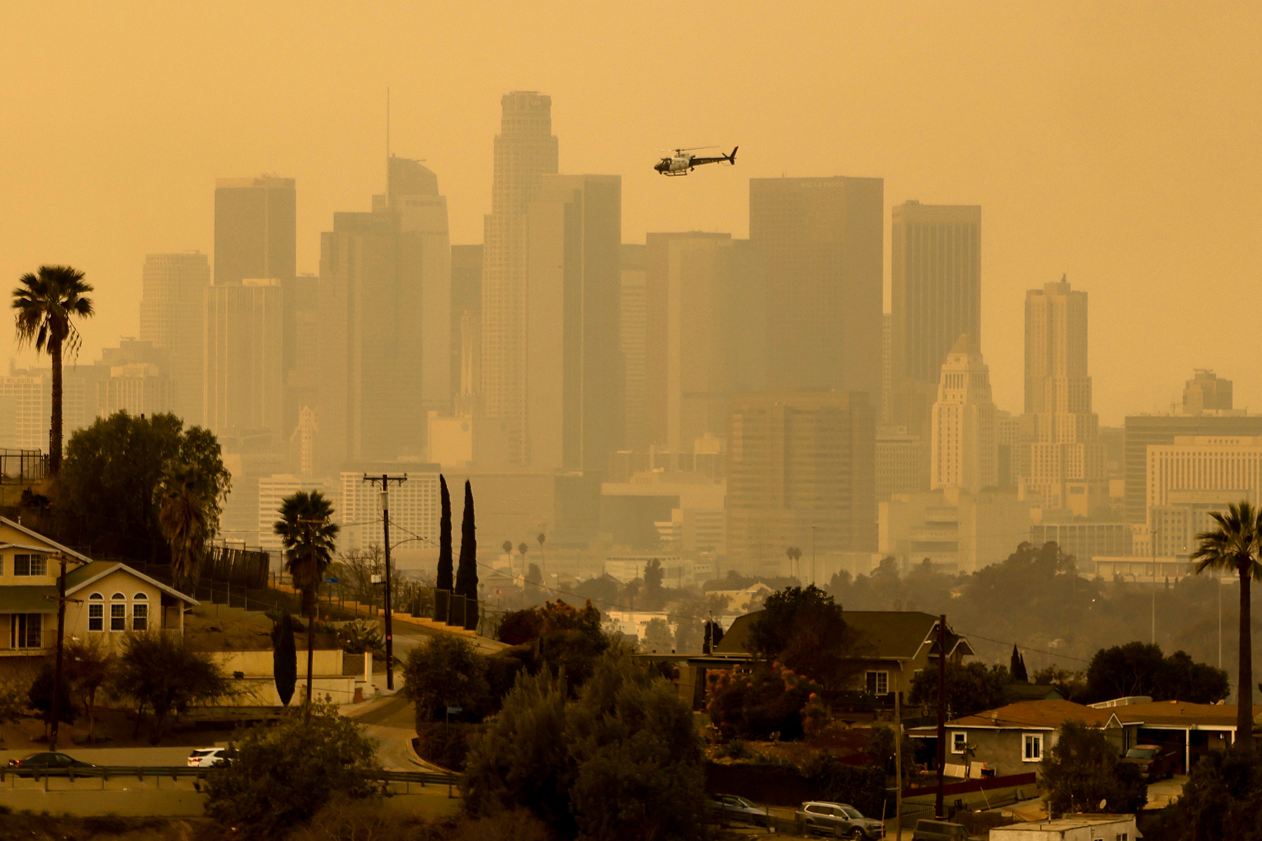 The sky is filled with smoke from multiple wildfires around the Los Angeles city skyline on Thursday in Southern California. Wildfire danger was expected to continue on Friday