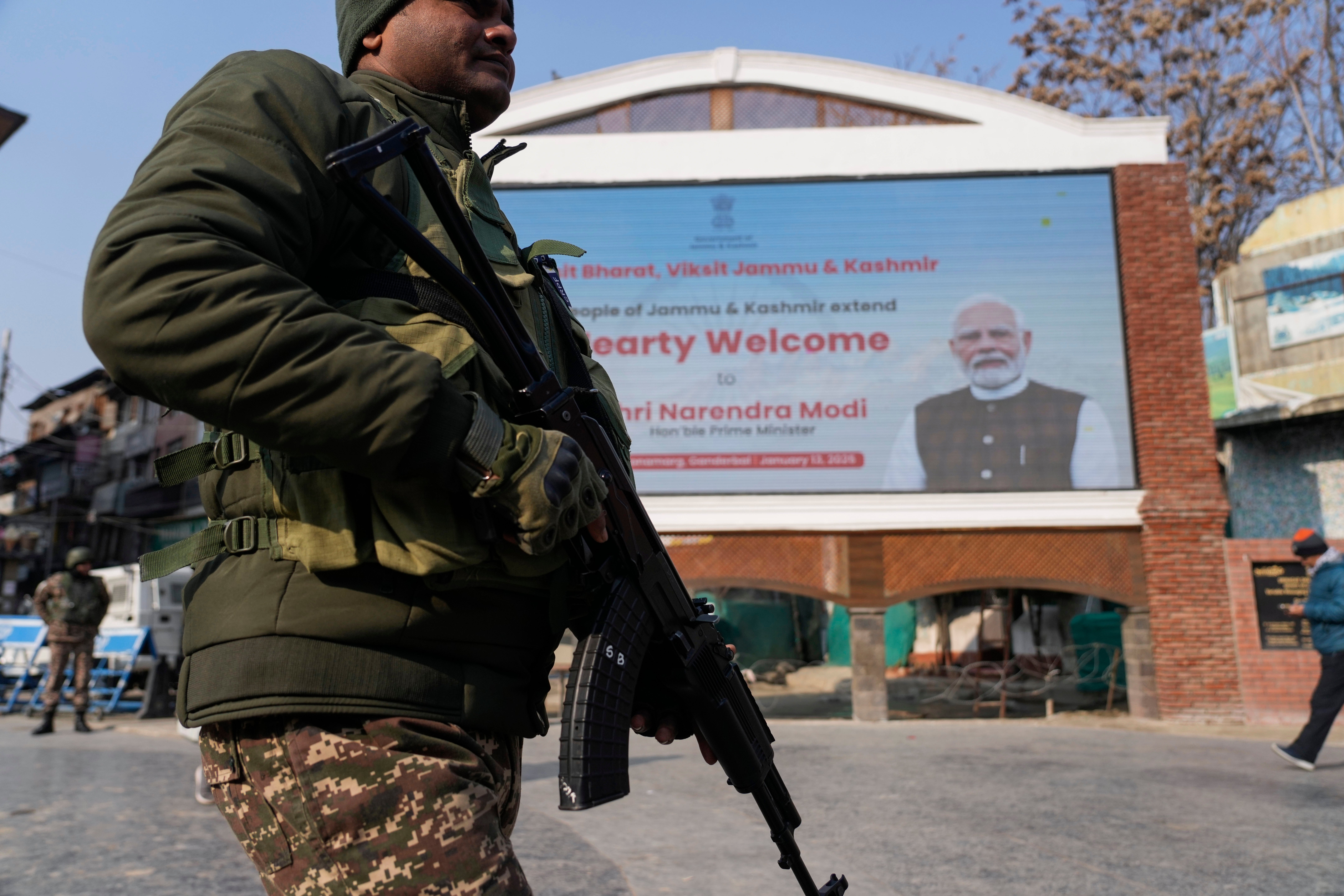 An Indian paramilitary soldier patrols near an electronic display in Srinagar, welcoming the Indian Prime Minister Narendra Modi to inaugurate a strategic tunnel project that connects Kashmir with Ladakh, 13 Jan 2025