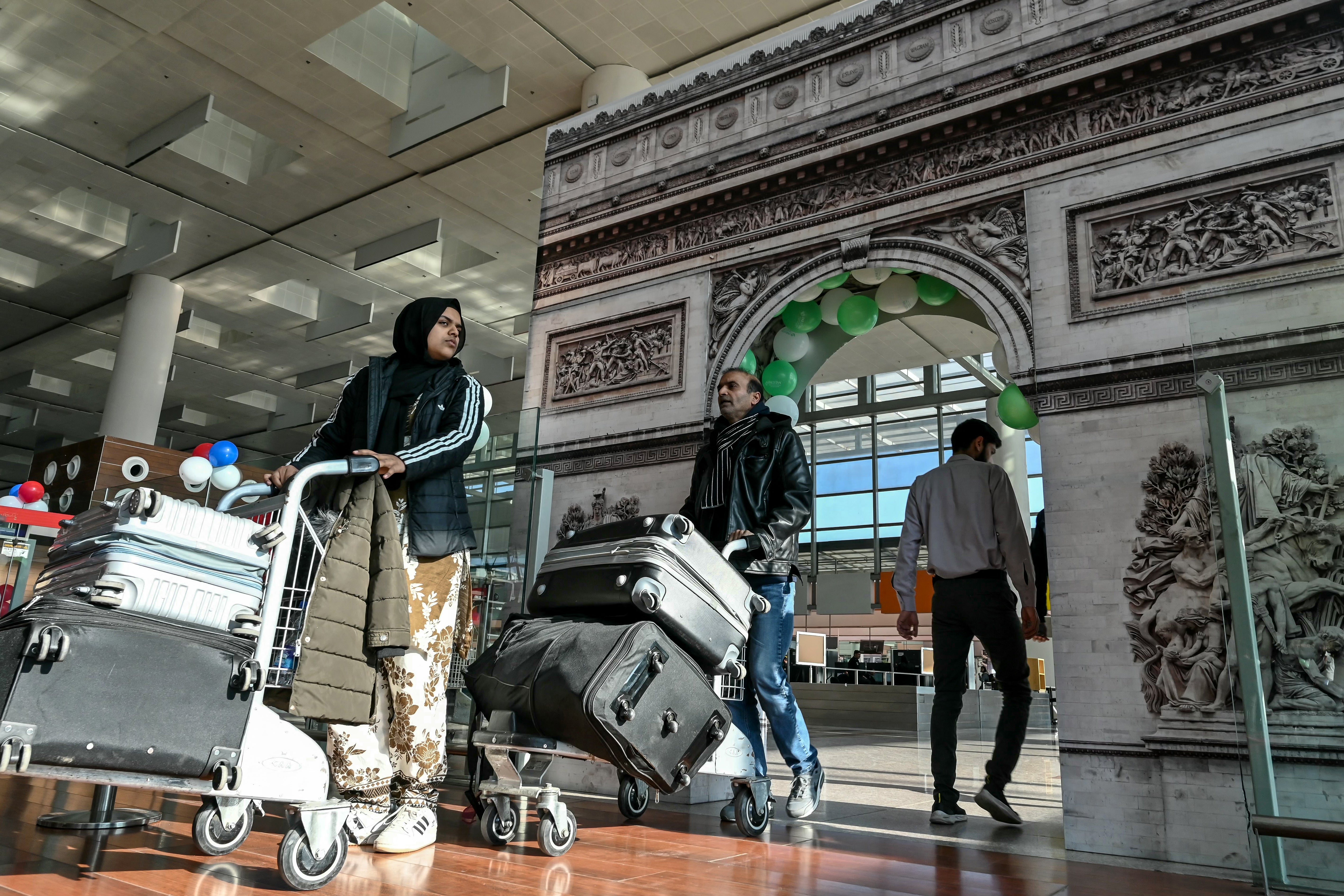 Passengers arrive at the immigration counter before boarding their Pakistan International Airlines flight to Paris at the Islamabad airport