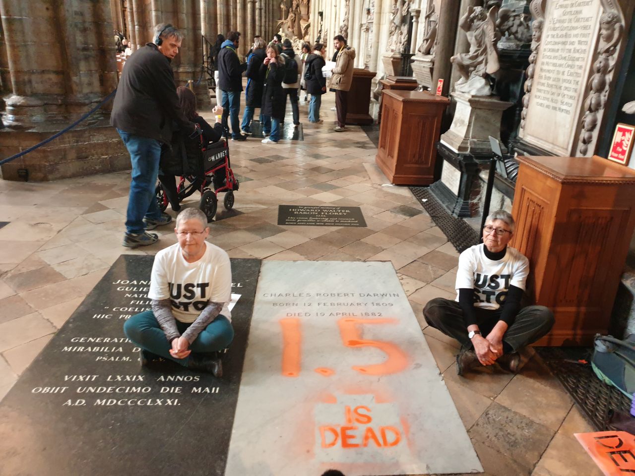 Just Stop Oil protesters paint Charles Darwin’s grave in Westminster Abbey to demand that the UK government work with others to phase out the extraction and burning of fossil fuels by 2030