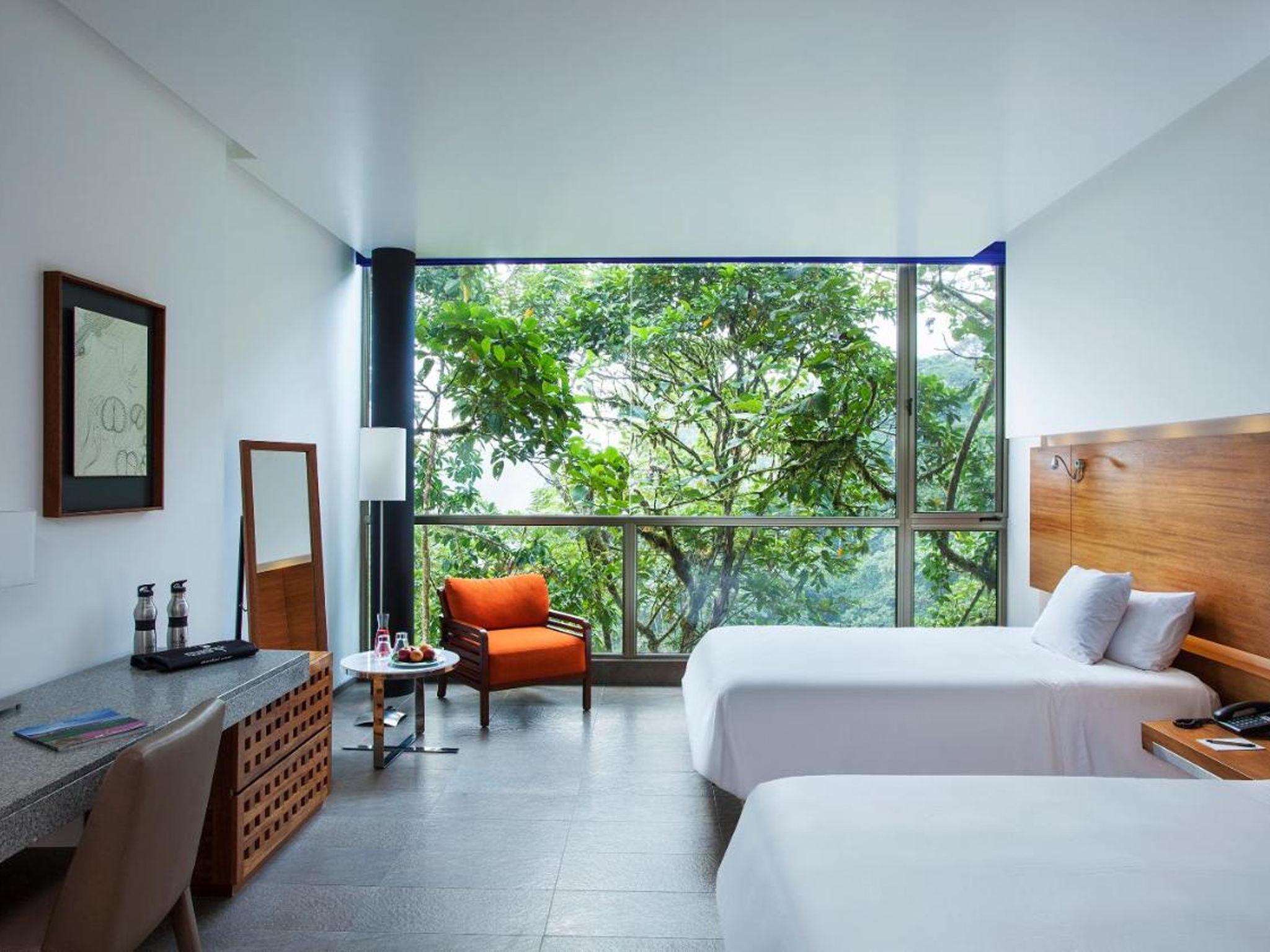 Every bedroom boasts floor-to-ceiling glass windows, offering an incredible view into the canopy