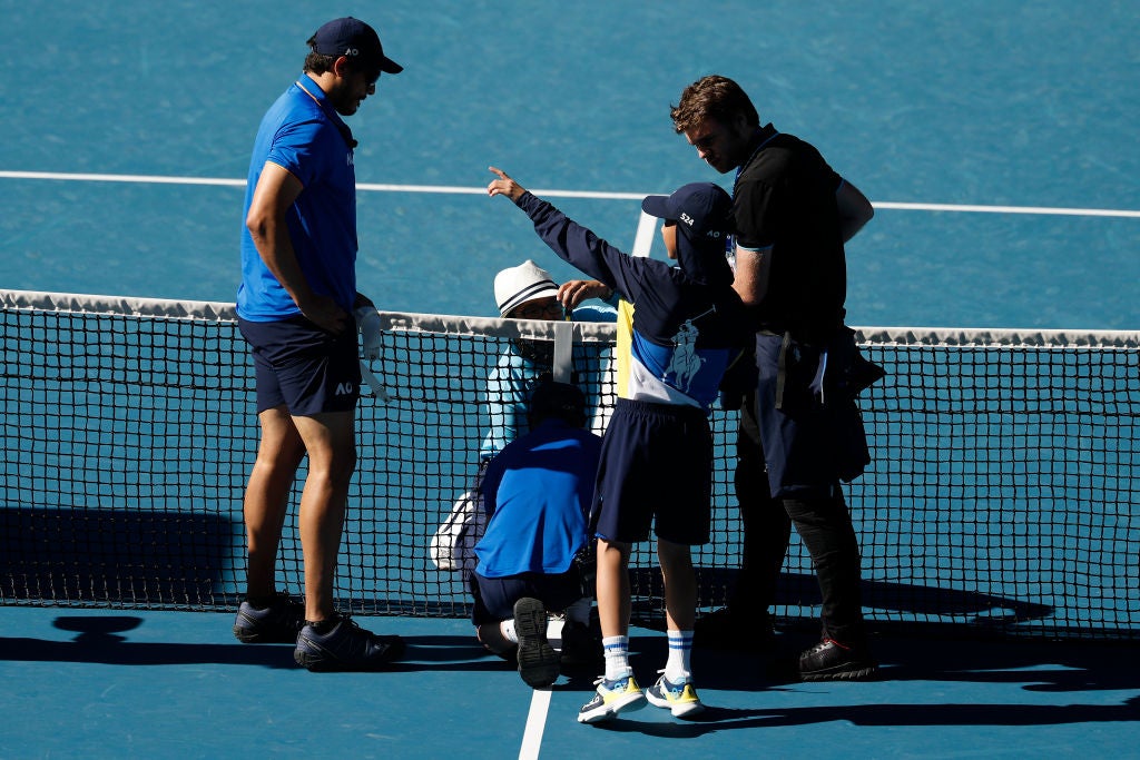 The clean-up operation begins on Rod Laver Arena