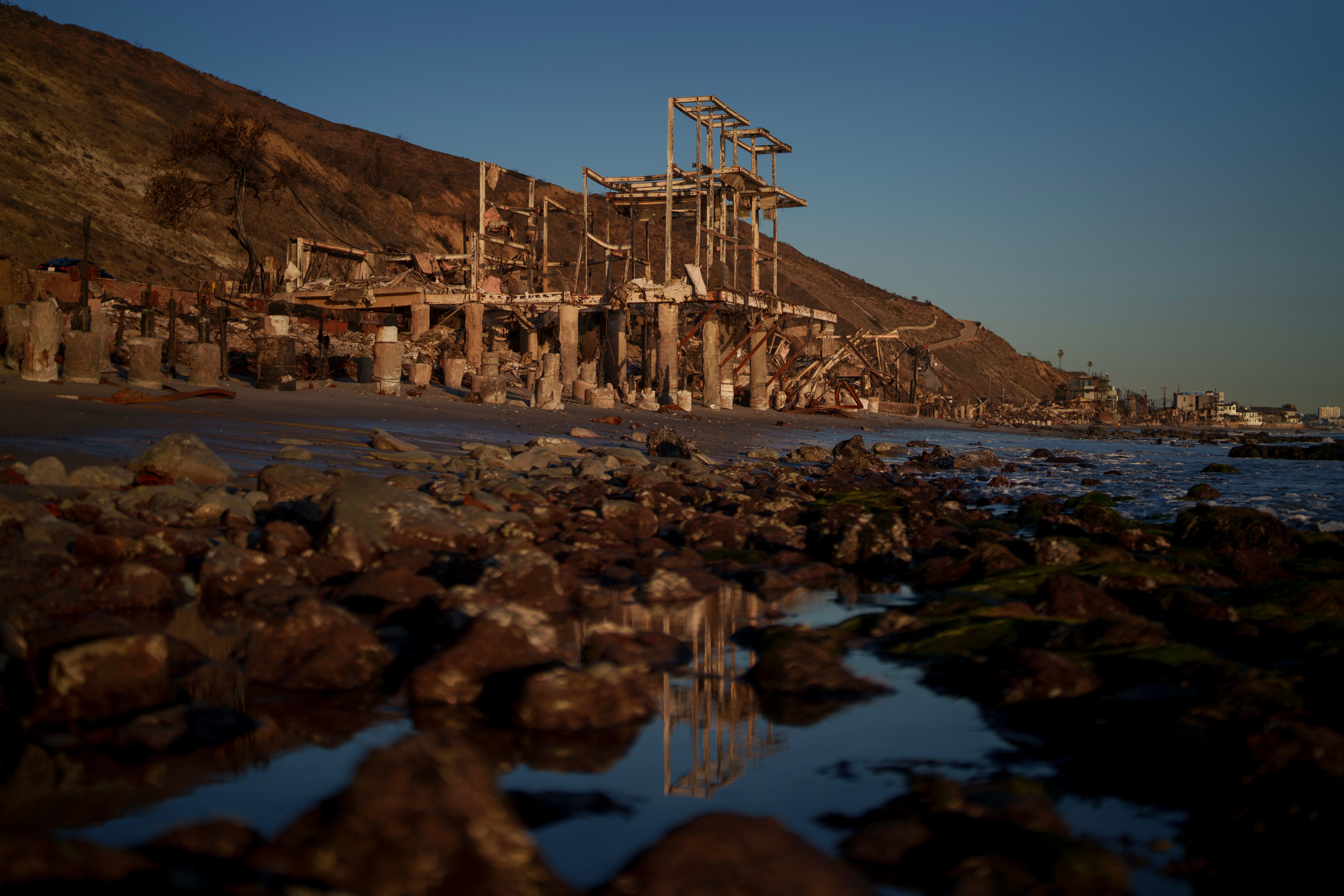 A destroyed home is seen as wildfires cause damage and loss through LA region