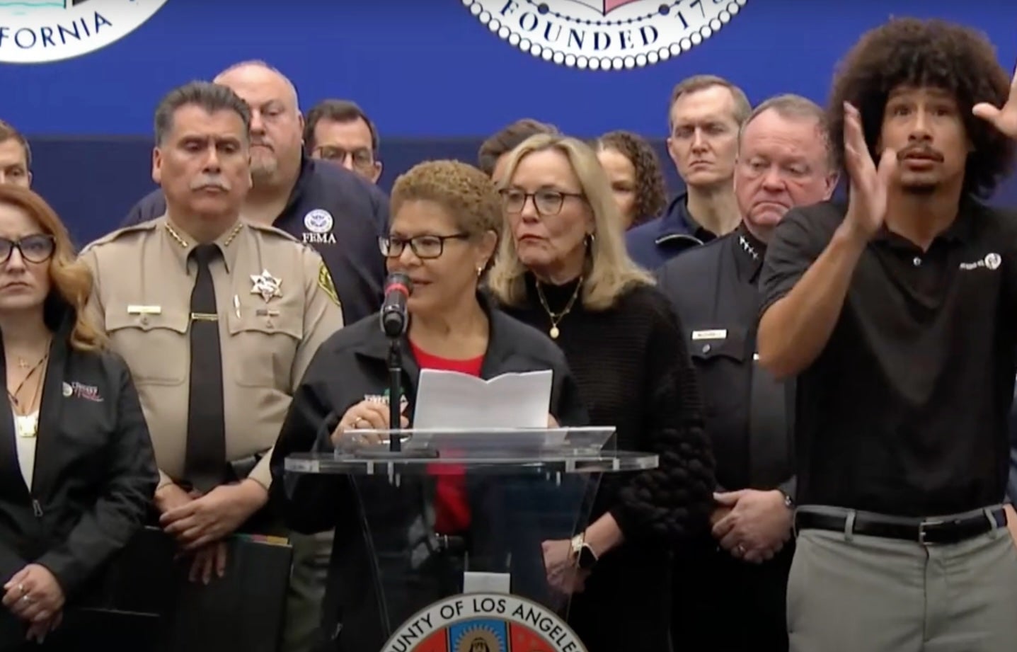 Messages from Los Angeles Mayor Karen Bass, pictured speaking at a press conference in January, to her staffers on the ground in the U.S. have been revealed. Communications were hit with some technical issues while the mayor was anxious to get back to L.A.