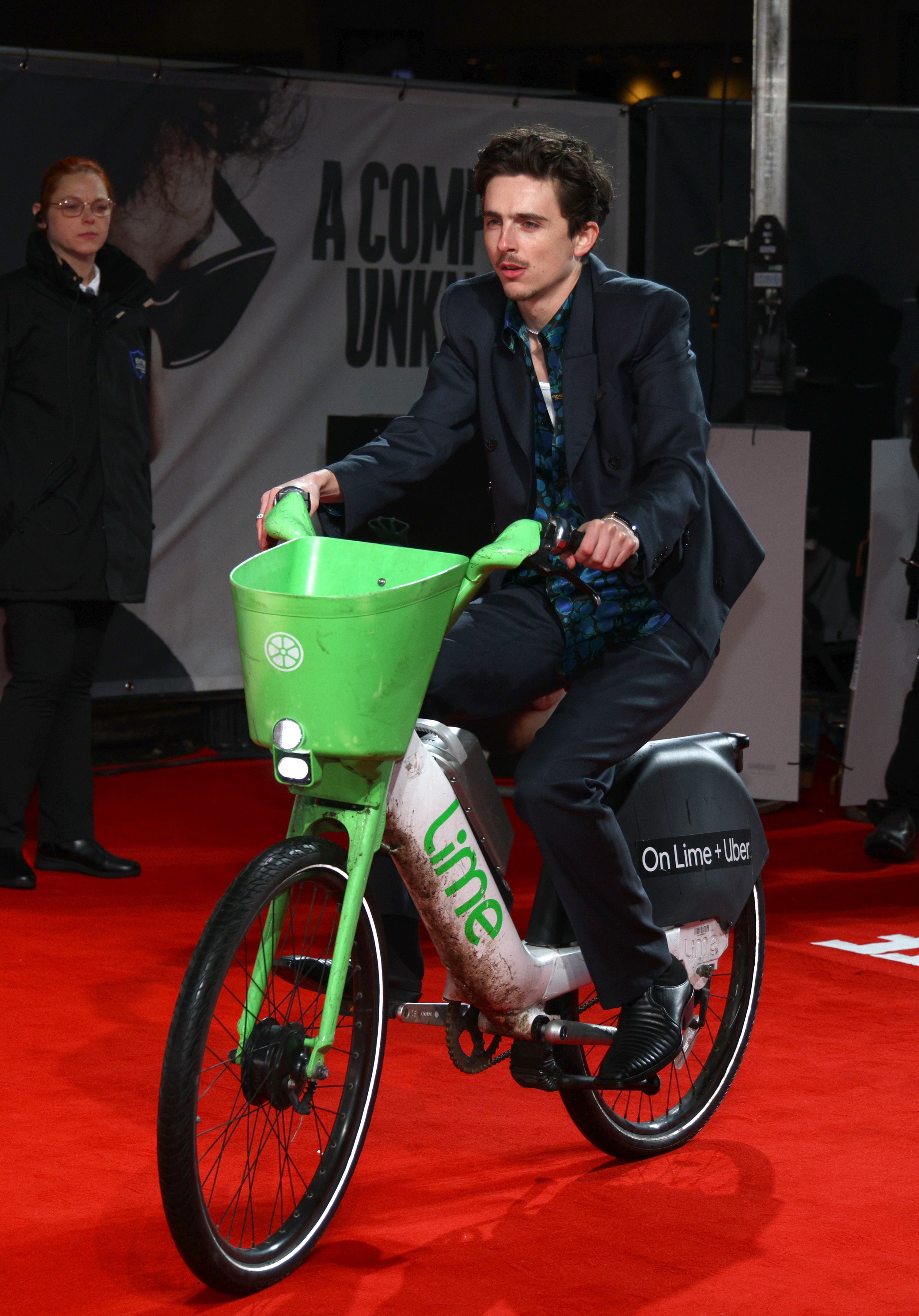 Timothée Chalamet riding a lime bike on the red carpet movie premiere