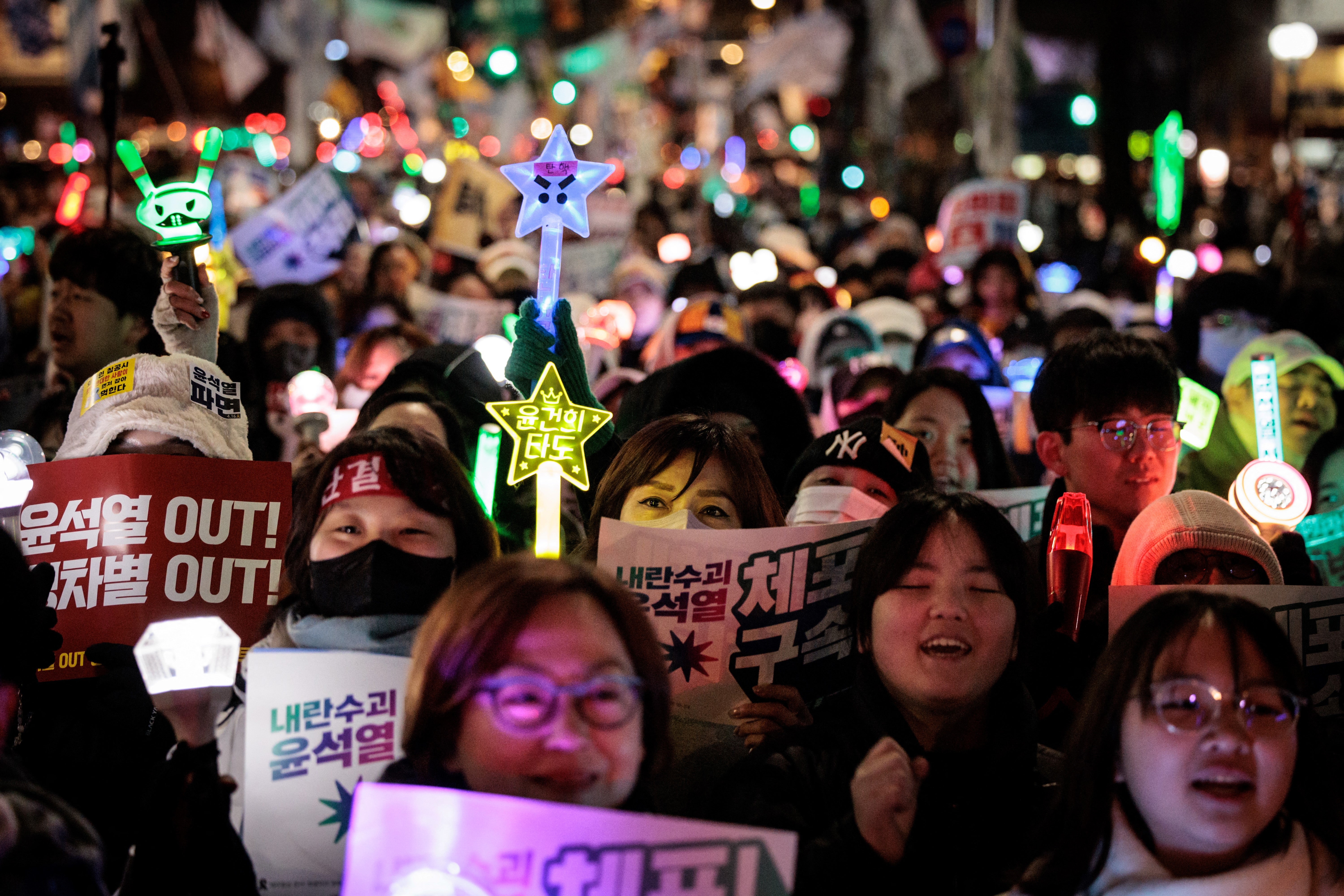 Protesters take part in a demonstration against impeached South Korean president Yoon Suk Yeol as they march on a street in Seoul on January 11
