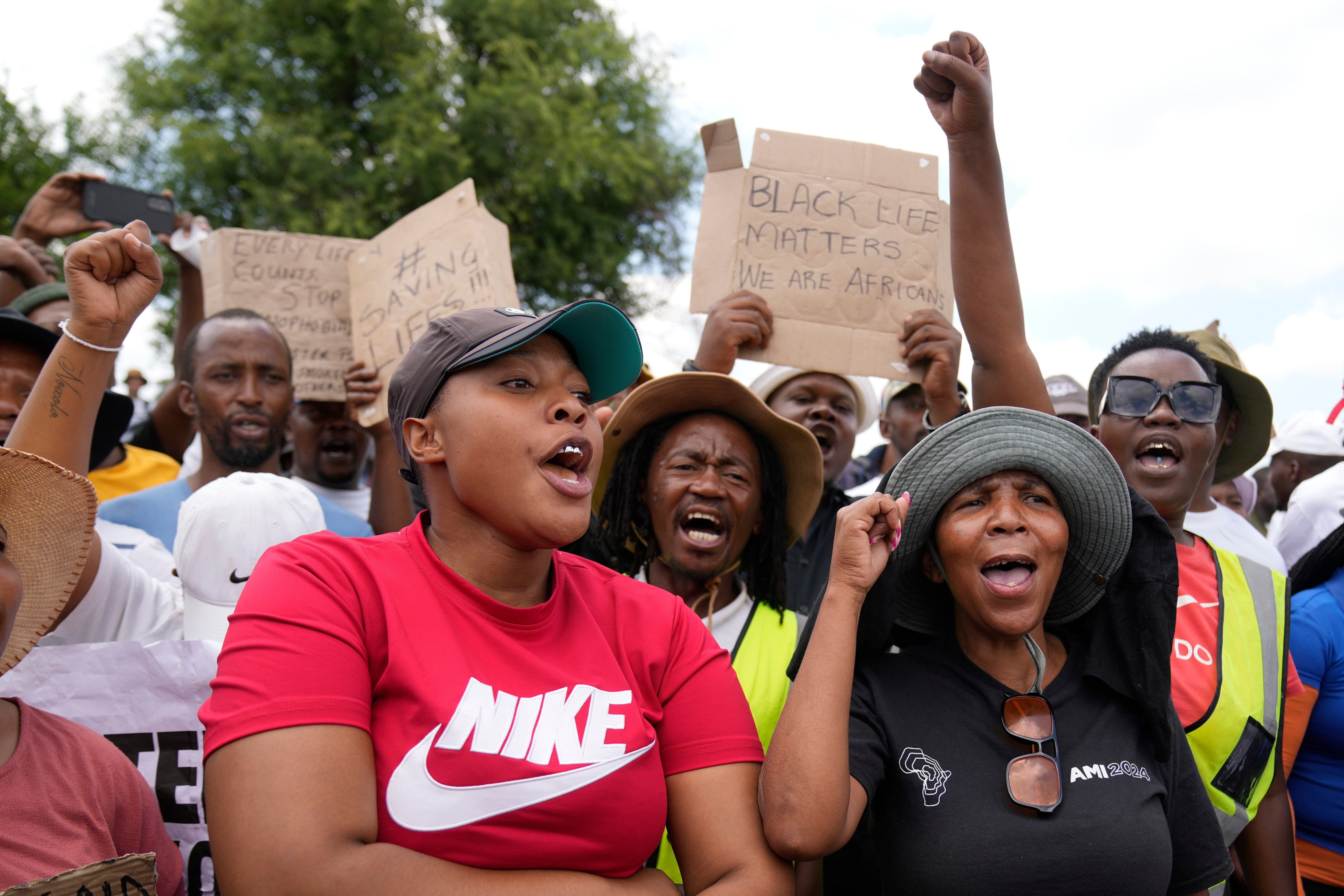 Families of miners and activist protest as South Africa's Police minister Senzo Mchunu visit the gold mine