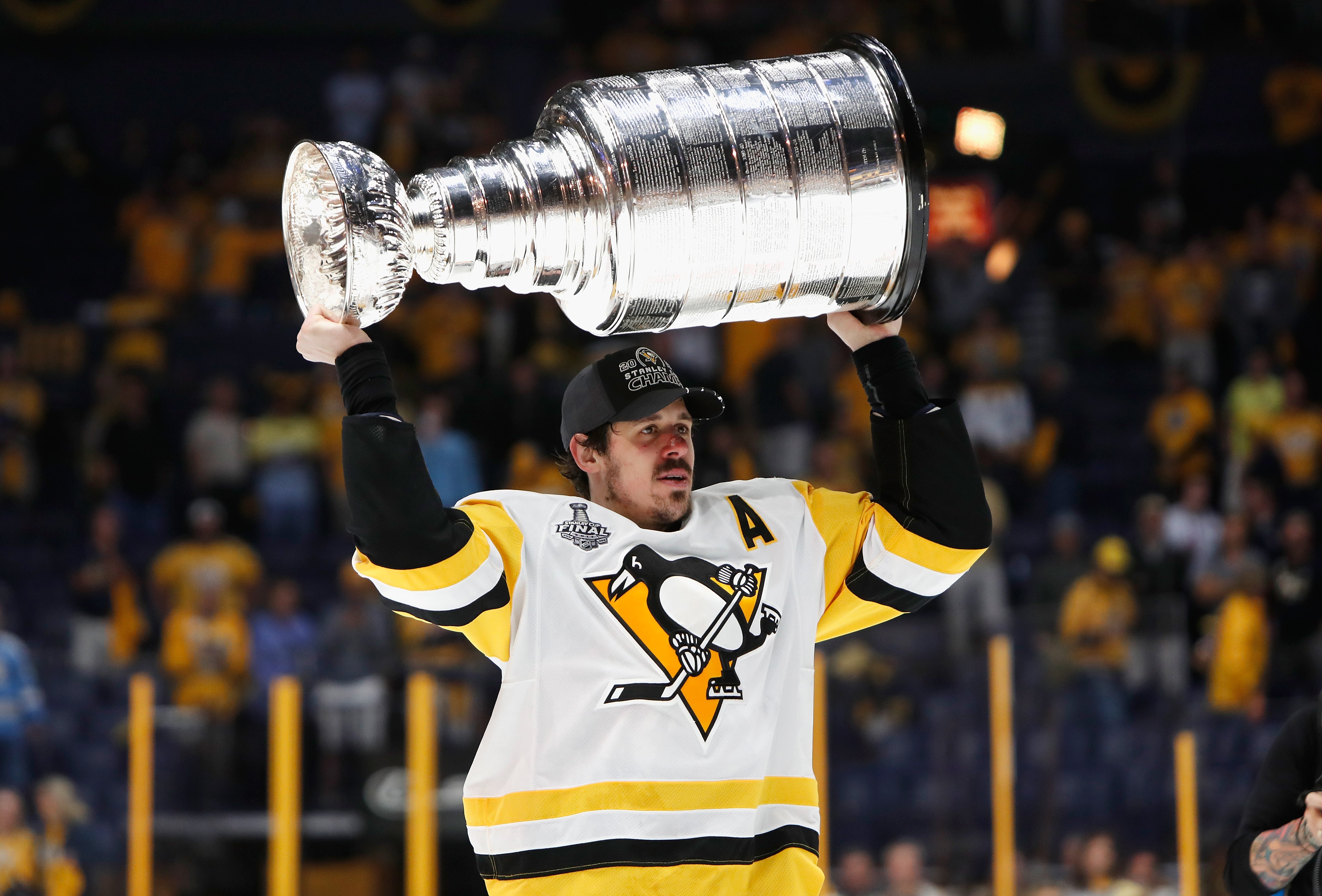 Evgeni Malkin #71 of the Pittsburgh Penguins celebrates with the Stanley Cup Trophy after they defeated the Nashville Predators 2-0 in Game Six of the 2017 NHL Stanley Cup Final at the Bridgestone Arena on June 11, 2017 in Nashville, Tennessee