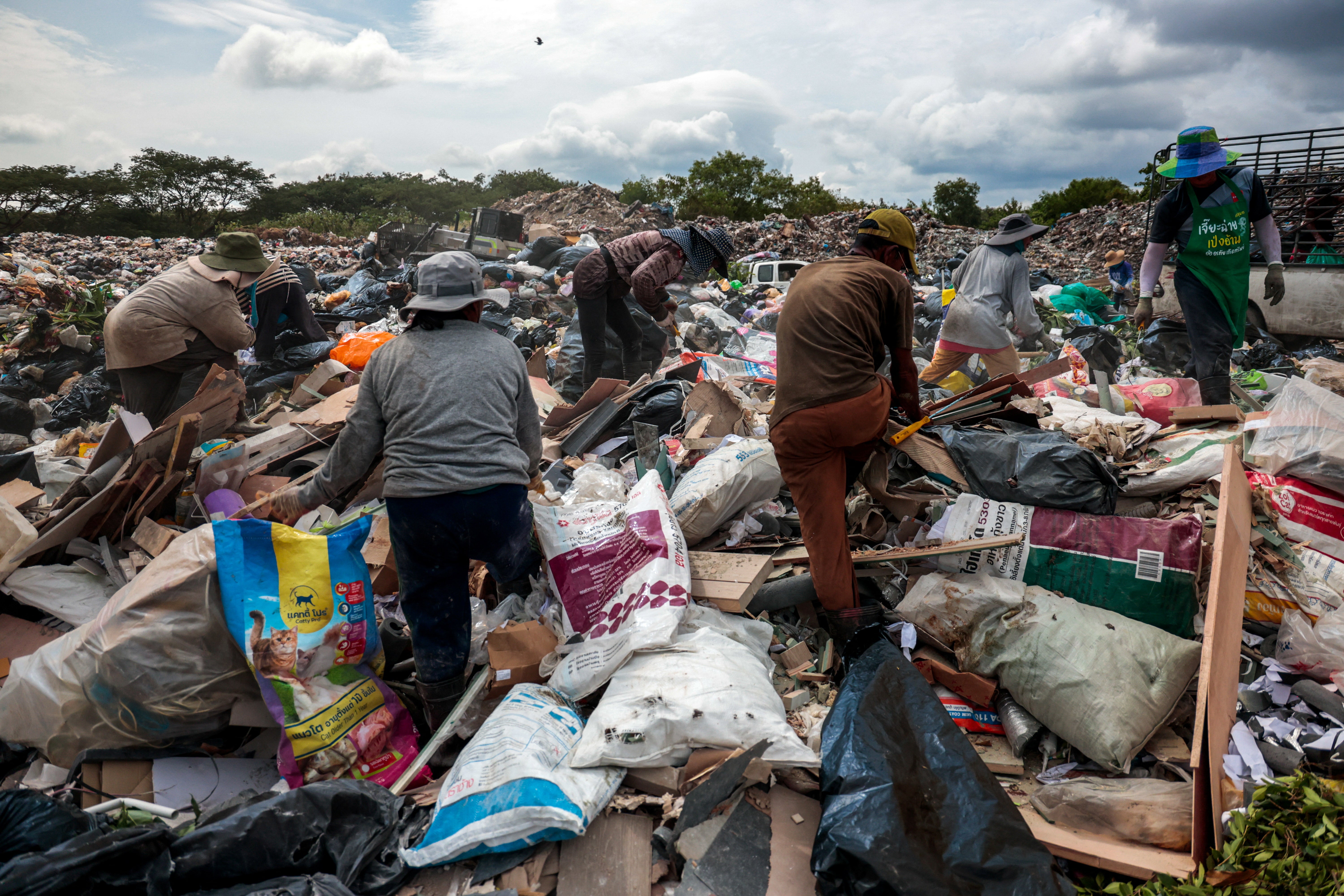 People work in the growing landfill in Phuket