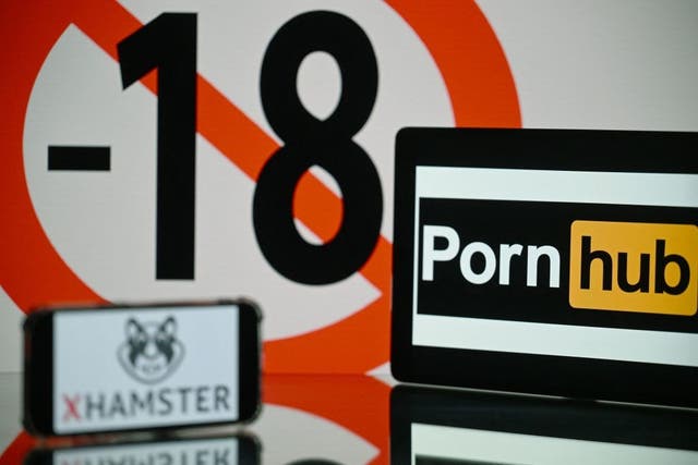 <p>An age restriction warning sign and the logos of the pornographic sites Pornhub and Xhamster, pictured in Toulouse, France, on 24 May, 2022</p>