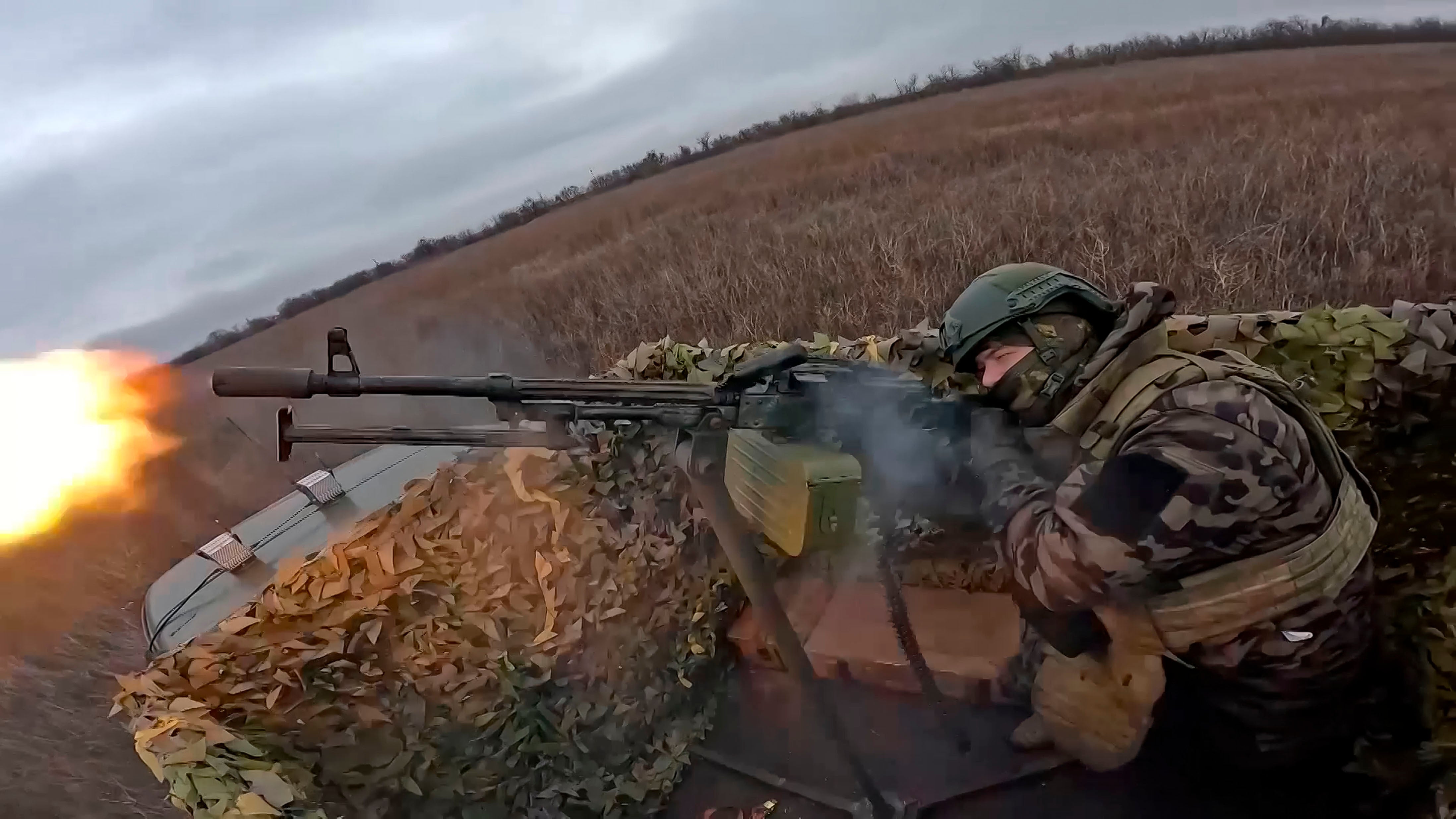 In this photo, taken from video and released by the Russian Defence Ministry Press Service on Thursday 16 January 2025, a Russian soldier tries to shoot a Ukrainian drone on an undisclosed location in Ukraine