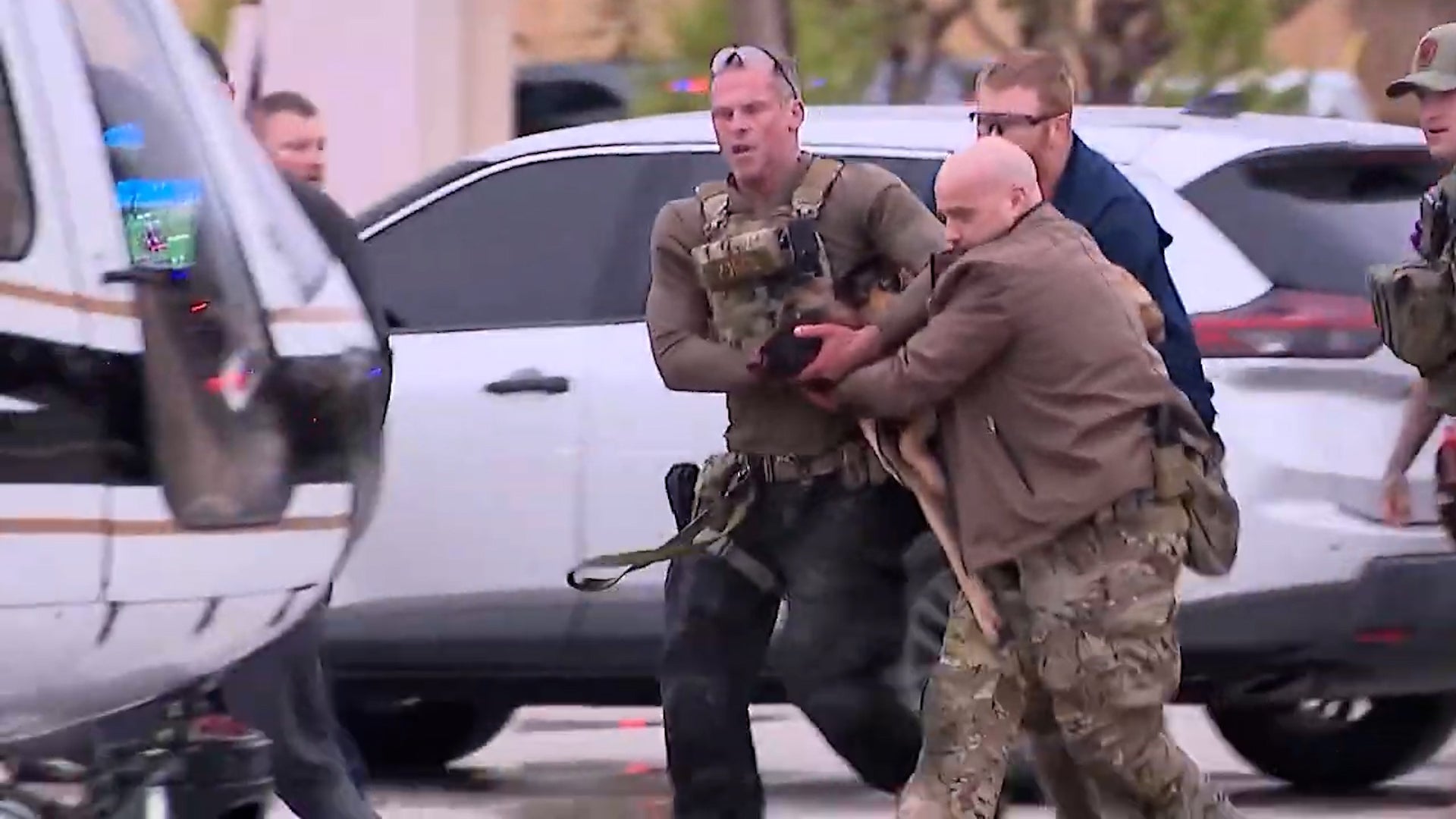 Police in Texas rush K9 officer Rocky to an air ambulance after he was shot during a shootout with an armed suspect on Wednesday