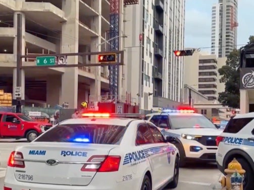 Miami police cars block an intersection on January 16, 2025, as part of their investigation into a man who attacked four homeless people earlier that morning, killing two.