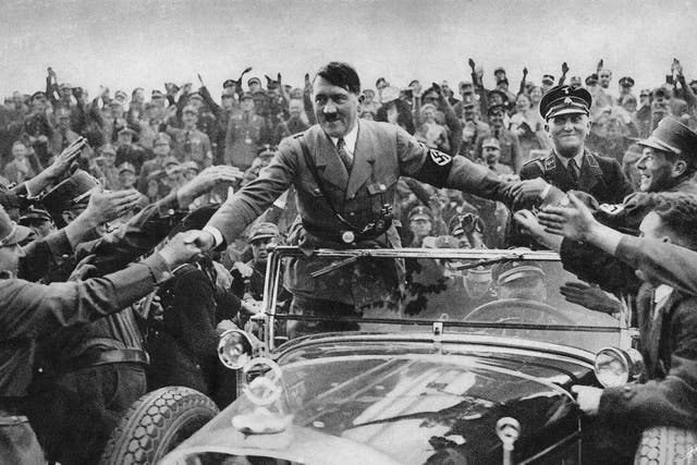 <p>Adolf Hitler, then chancellor of Germany, is welcomed by supporters at Nuremberg in 1933 </p>