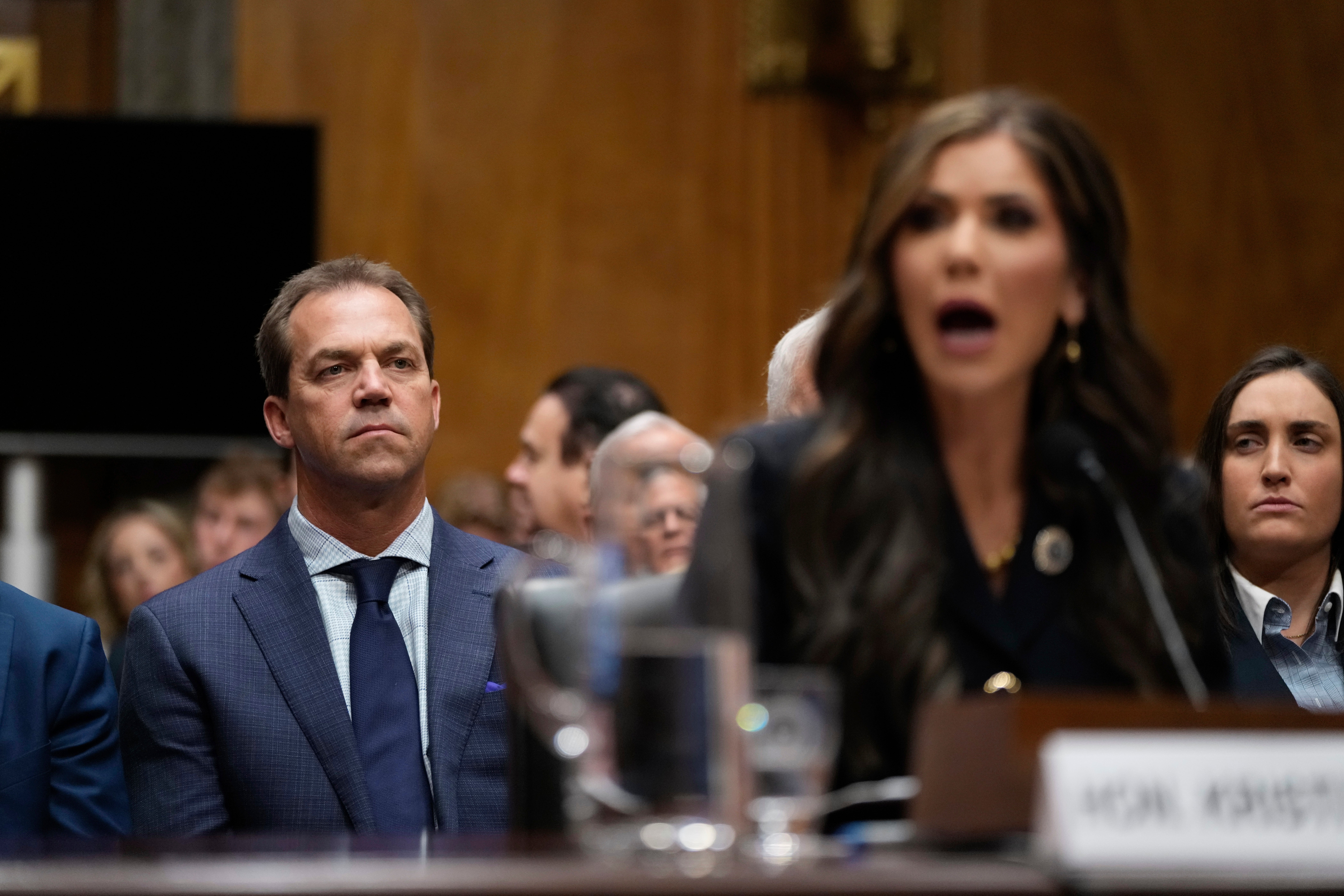 Bryon Noem with his wife as she appeared before the Senate Homeland Security and Governmental Affairs Committee for her confirmation hearing