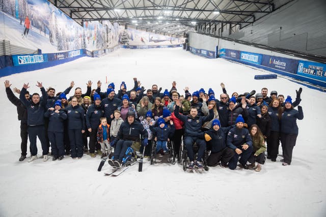 Competitors, friends and family gather for a photo during the final training session for Royal British Legion Team UK at the SnowDome in Tamworth, Staffordshire (Aaron Chown/PA)