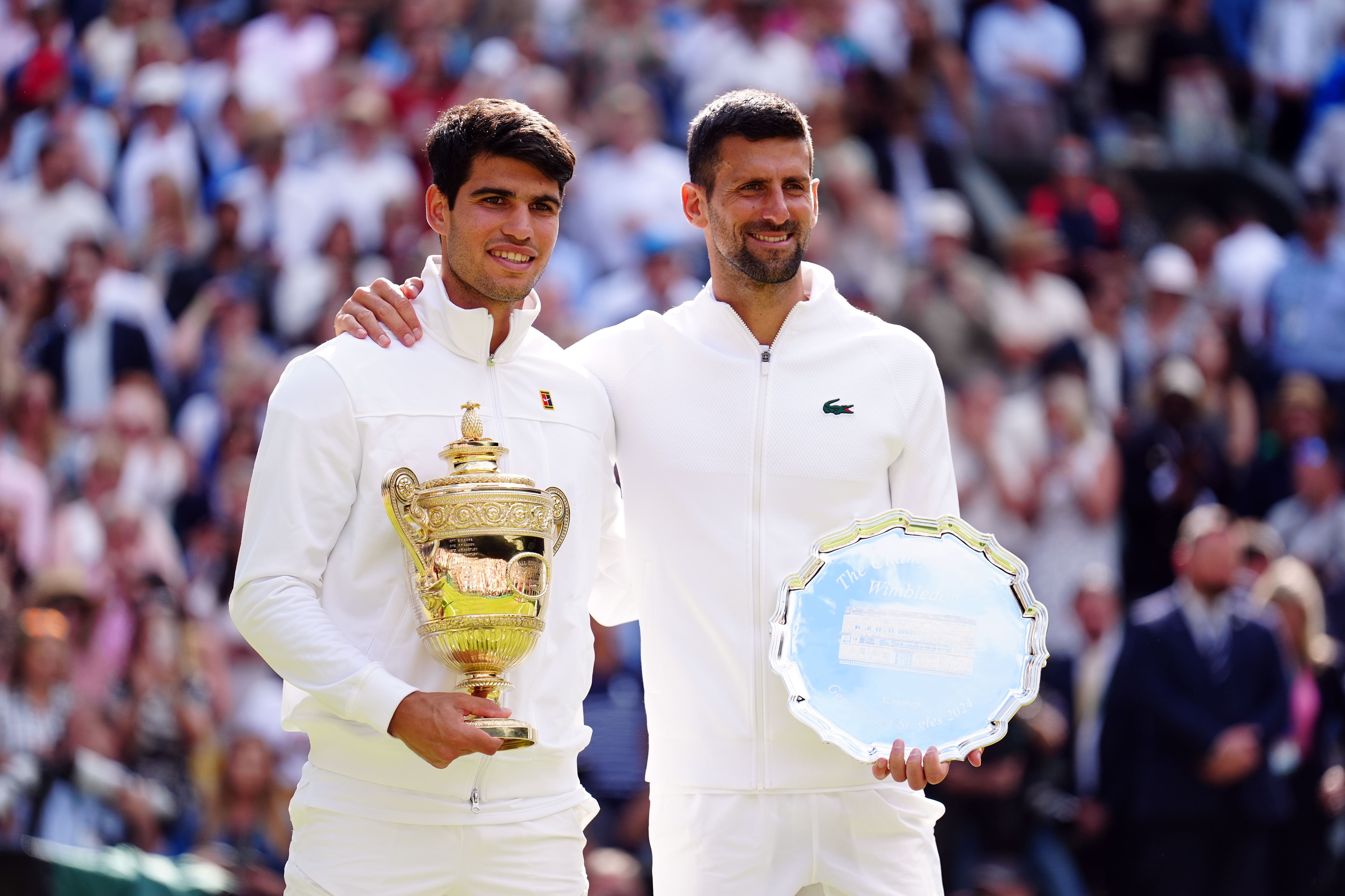 Carlos Alcaraz, left, and Novak Djokovic with their Wimbledon trophies (Mike Egerton/PA)