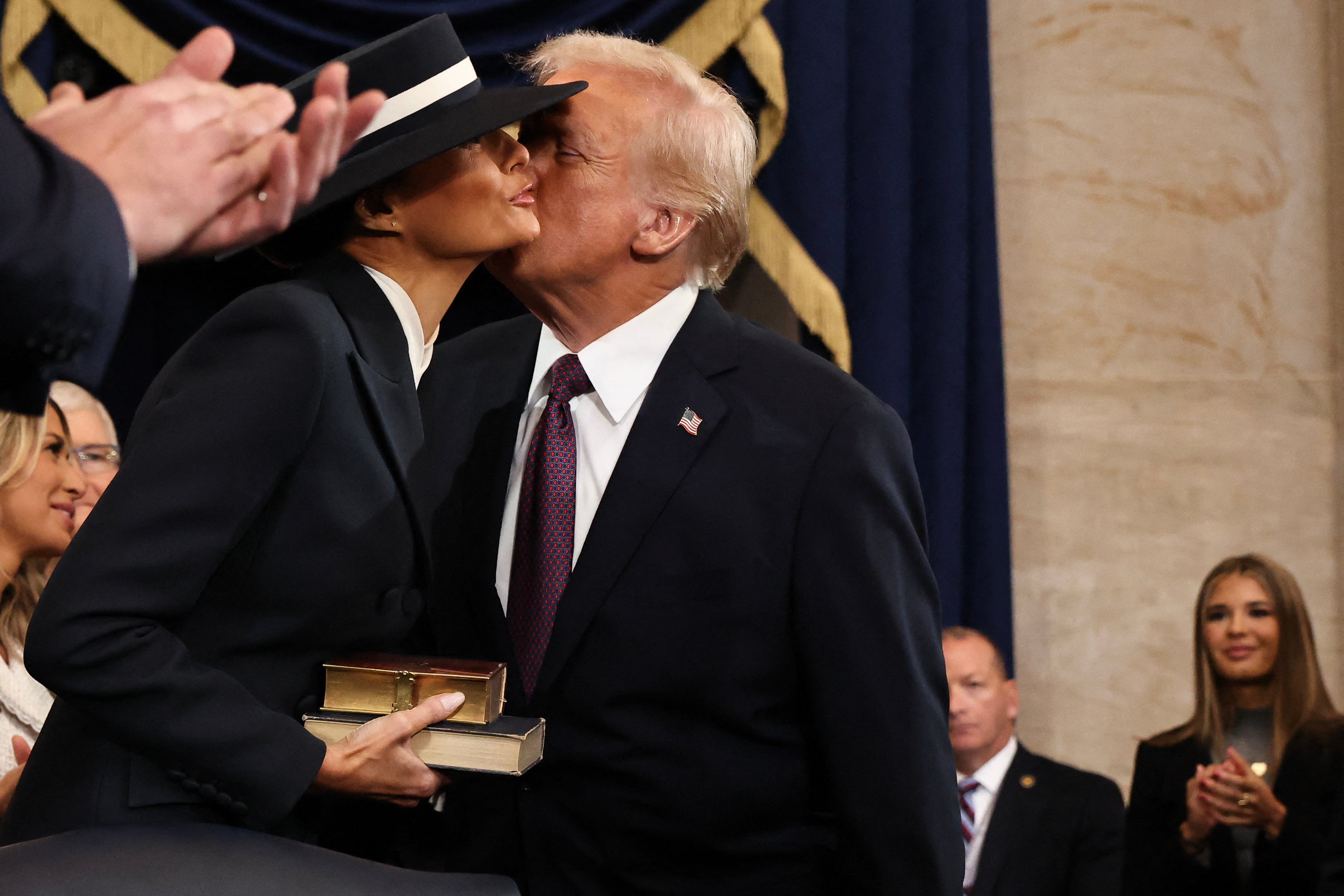 However after taking the oath, the new president was able to land a kiss on his wife’s cheek