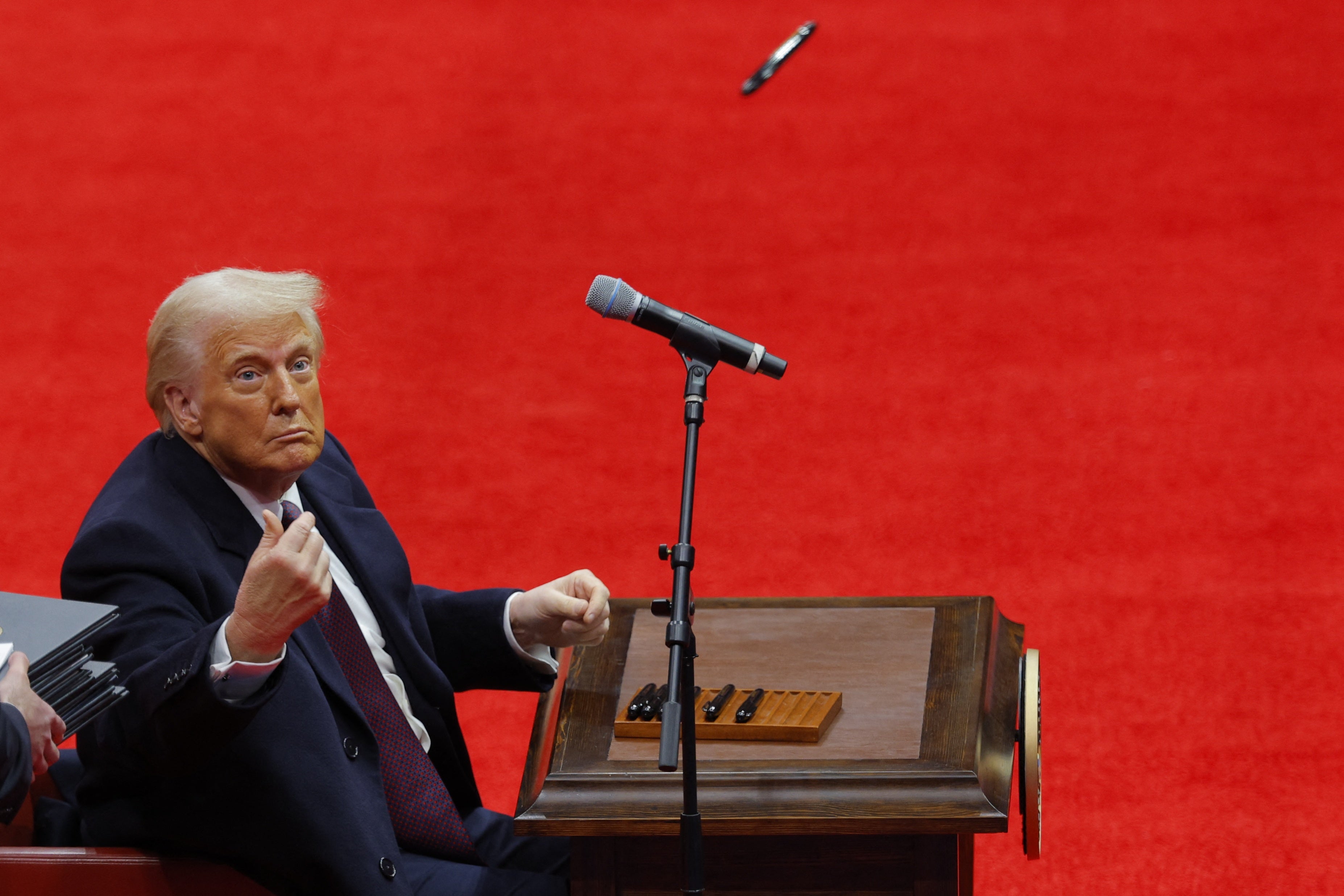 President Donald Trump throws a pen towards supporters after signing executive orders inside the Capital One Arena