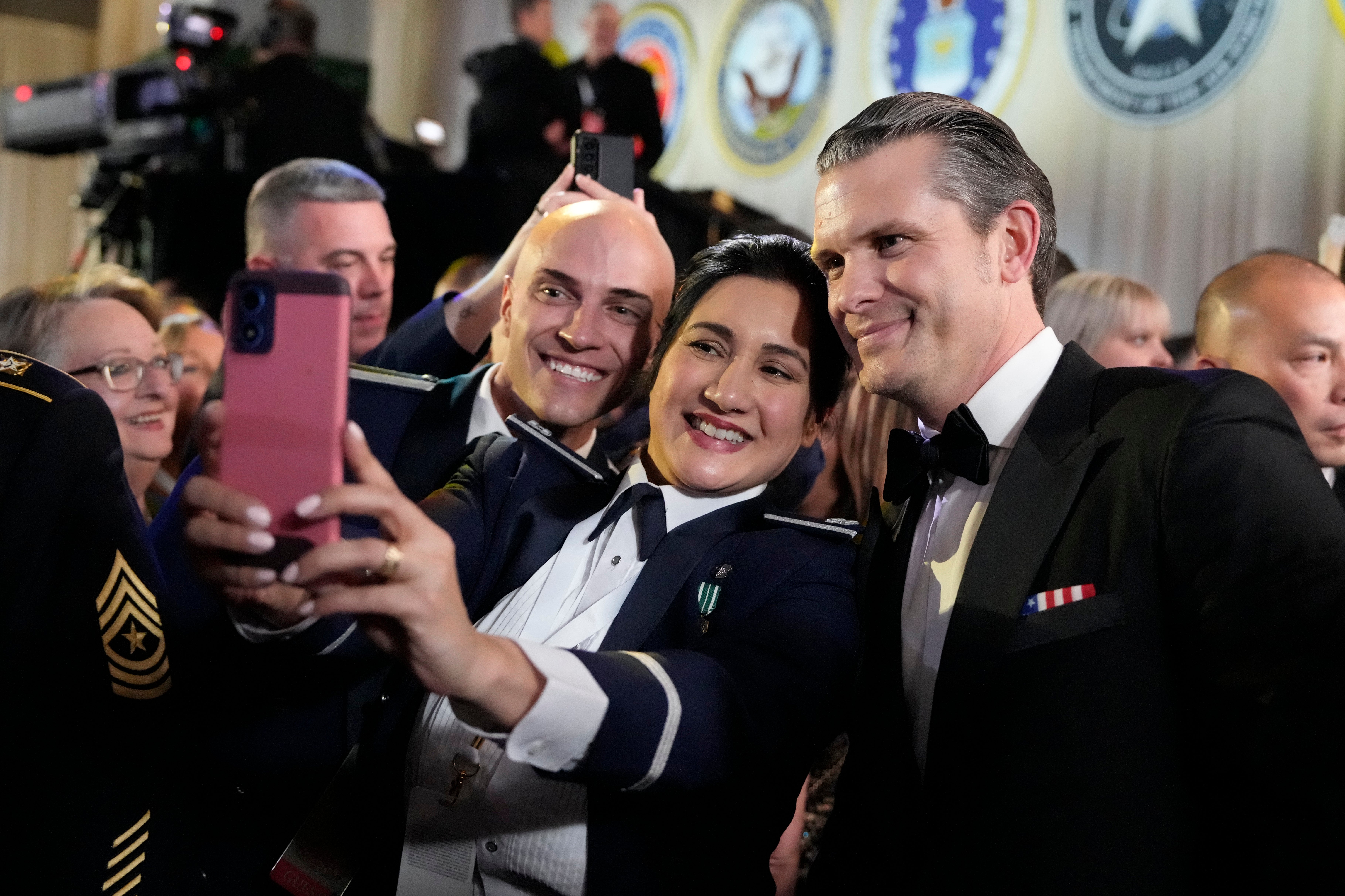 Trump Inauguration Defense Secretary nominee Pete Hegseth, right, takes a photo with members of the military at the Commander in Chief Ball, Monday