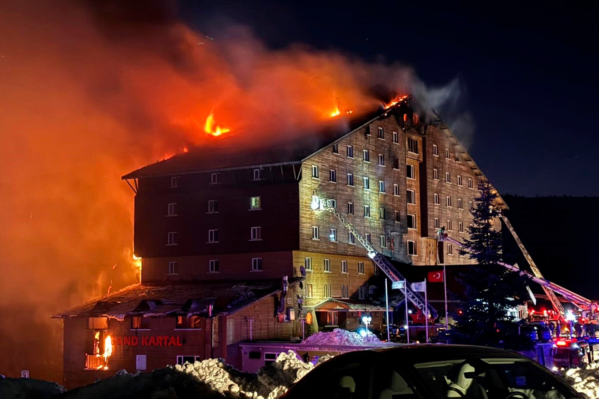 Firefighters work to extinguish a fire in a hotel at a ski resort of Kartalkaya in Bolu province