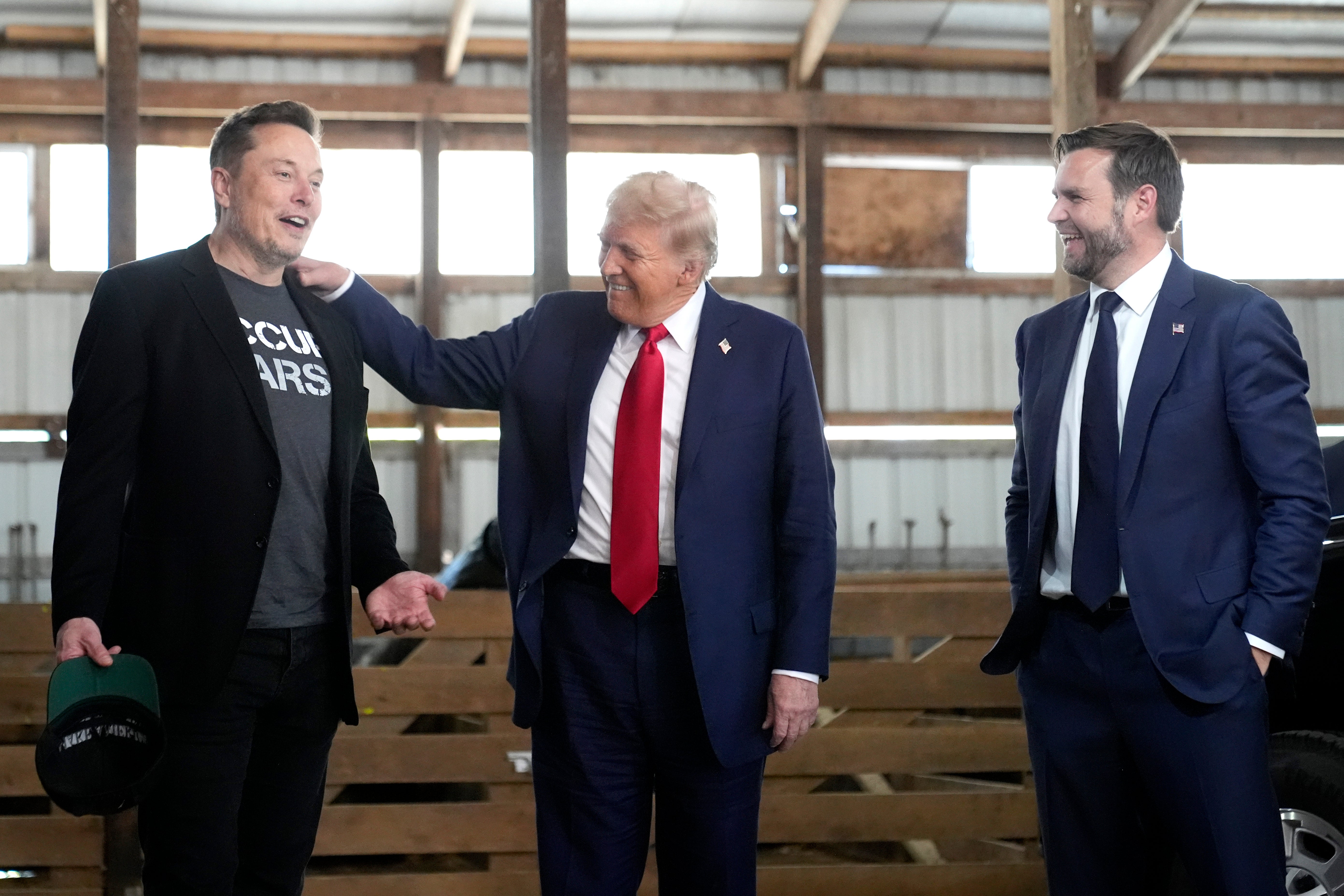 Musk (left), photographed beside Trump (middle) and Vance in Pennslyvania in October, took a swipe at The Atlantic just hours after Goldberg’s damning report was published on Monday