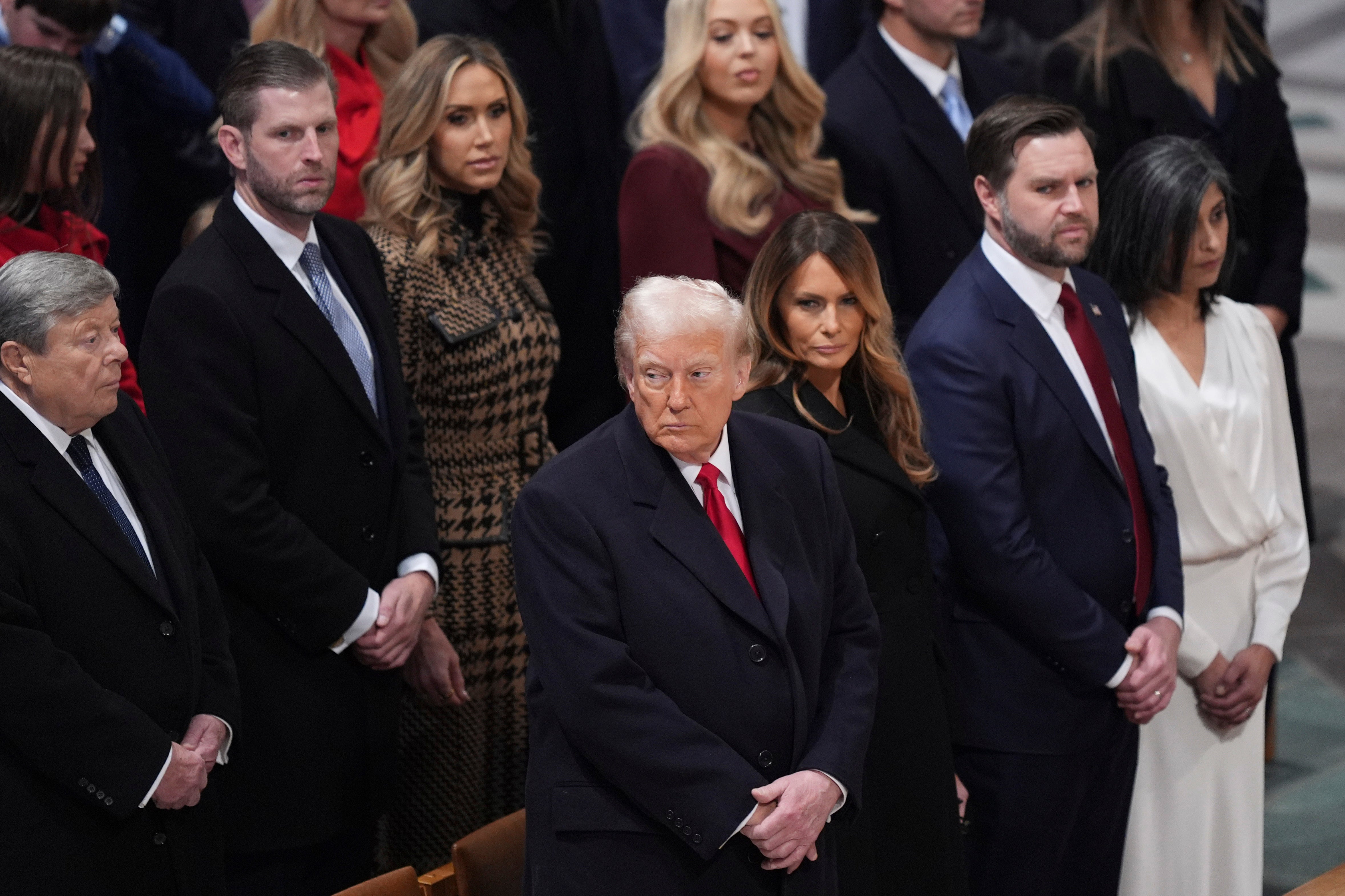 Lara Trump pictured behind her father-in-law at the National Prayer Service just after his inauguration in January