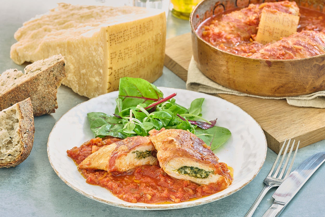 Pesto-stuffed chicken wrapped in pancetta cooked to perfection in rich tomato sauce
