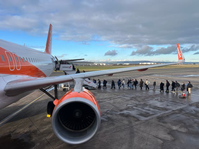 <p>Going places: Passengers boarding an easyJet flight from Belfast City airport to London Gatwick</p>