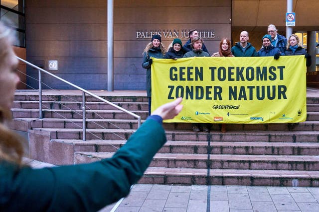 <p>Members of Greenpeace protest in front of the court in The Hague, the Netherlands, 22 January </p>