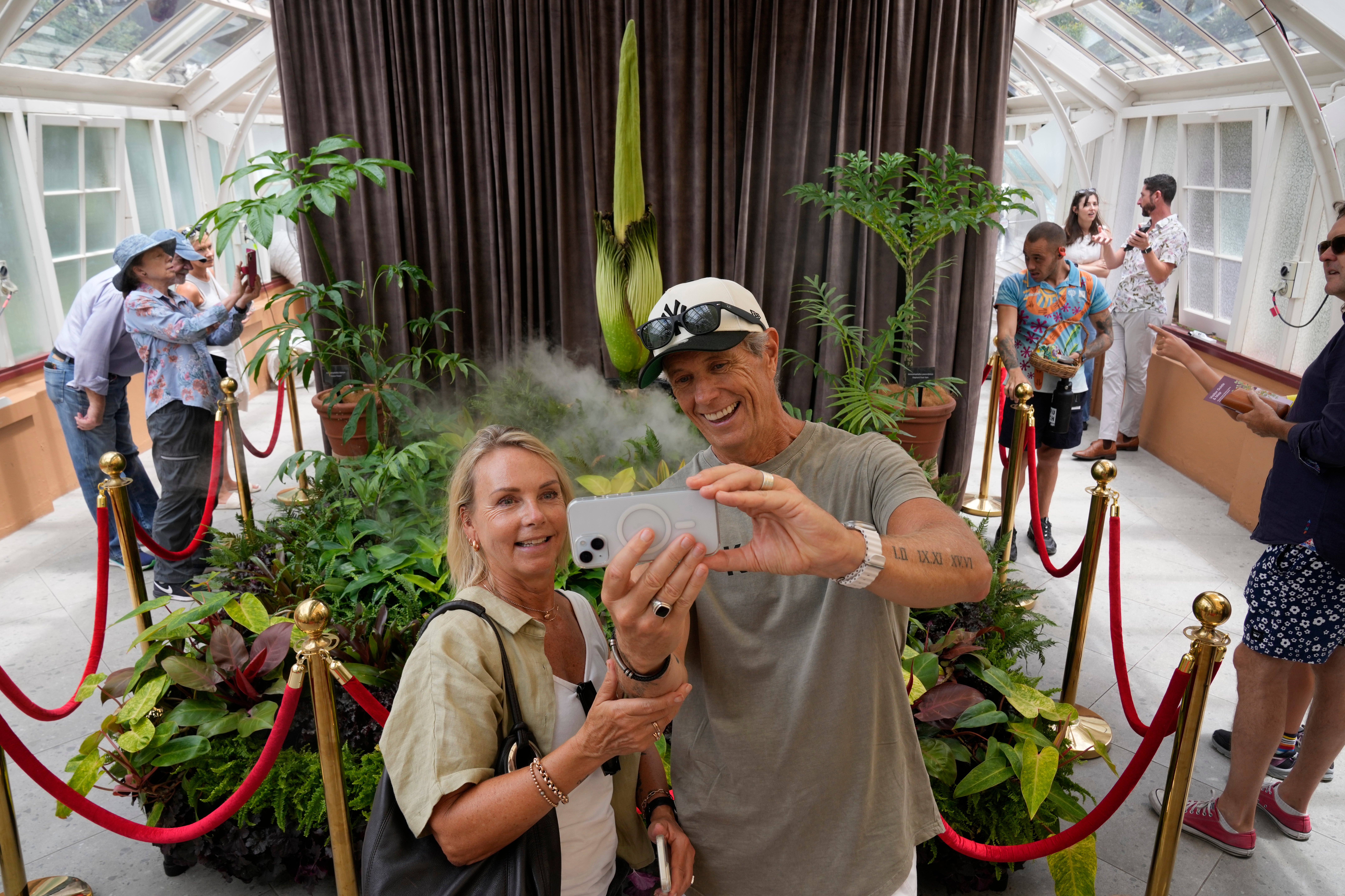 Karen and Wayne McKay photograph themselves with an endangered "corpse flower" at the Royal Botanical Gardens in Sydney