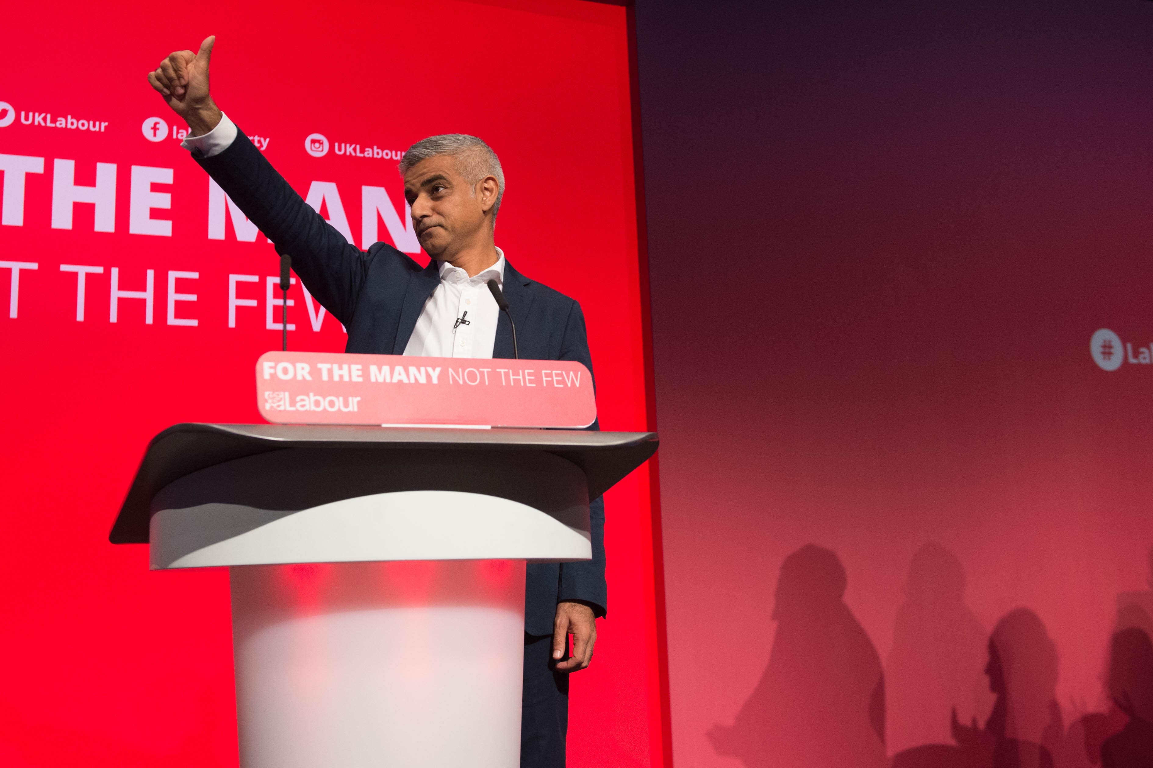 A different image from the same speech shows Mr Khan with his thumb stretched out (Stefan Rousseau/PA)