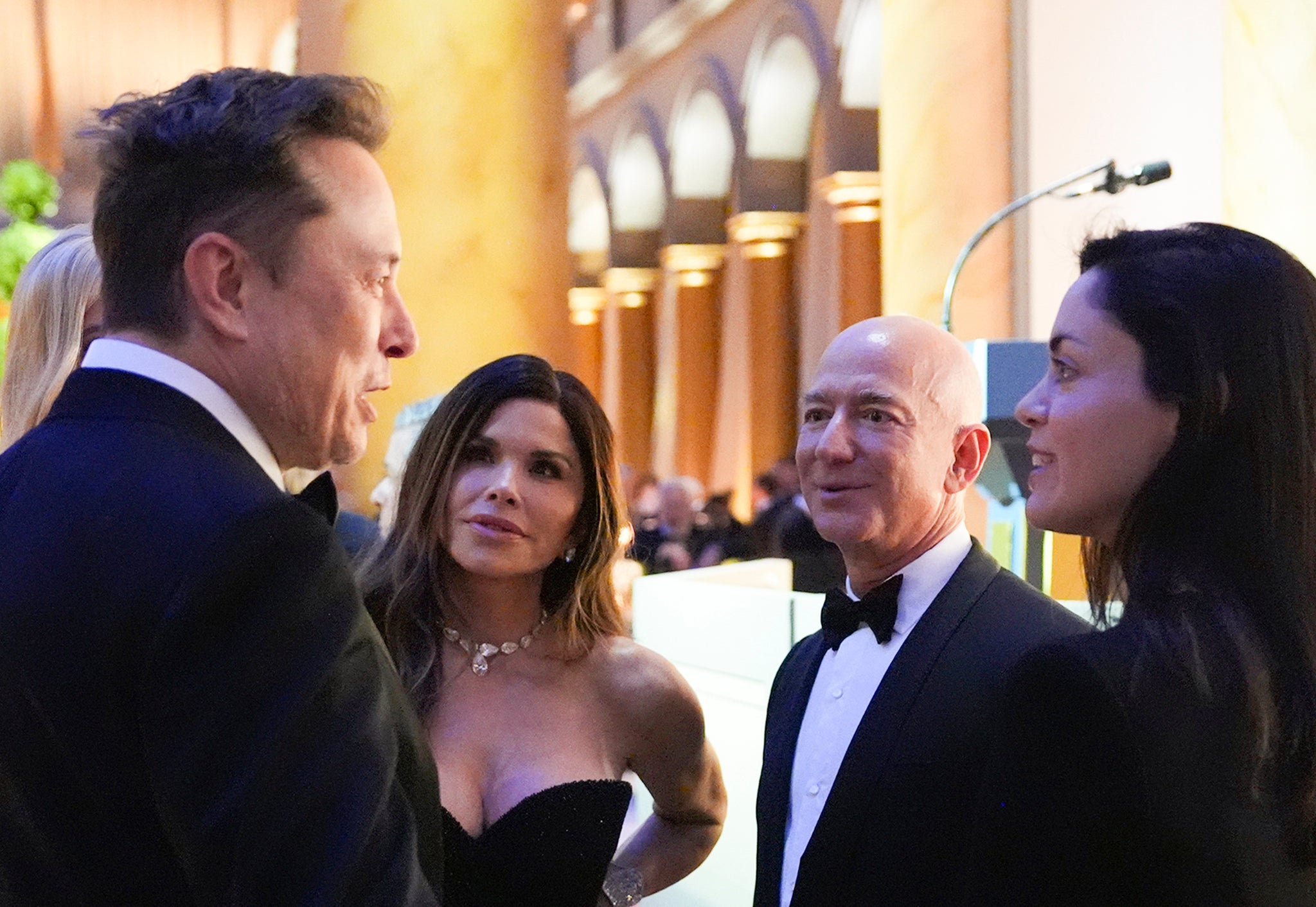 Elon Musk was pictured with Shivon Zilis (right) speaking to Jeff Bezos and his fiance Lauren Sanchez