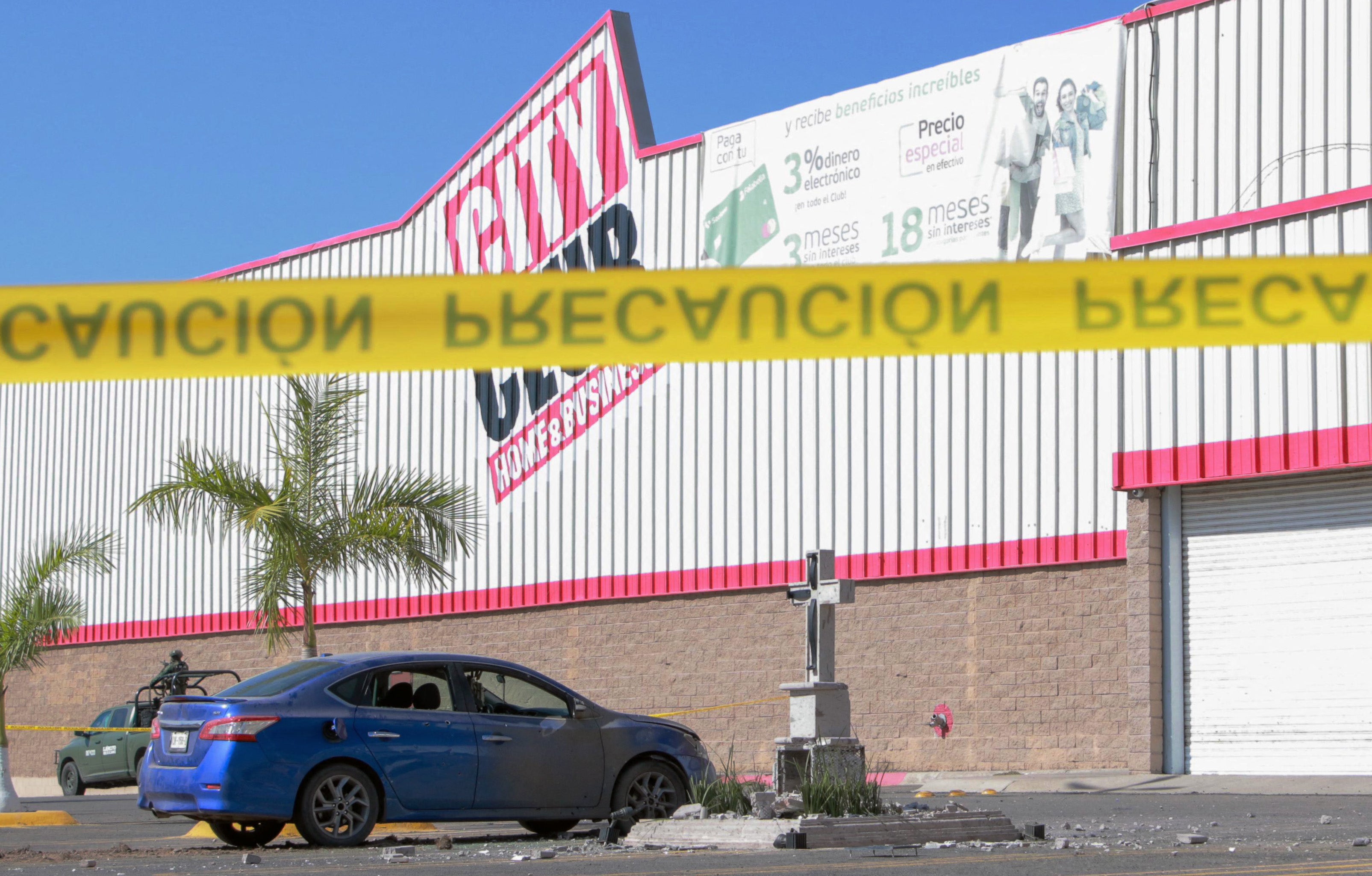 View of bullet-ridden car left next to the damaged memorial dedicated to Edgar Guzman Lopez, a son of ‘El Chap’" who was killed in 2008, after an explosion in the parking lot of a supermarket in Culiacan, Sinaloa State, Mexico, on January 23, 2025