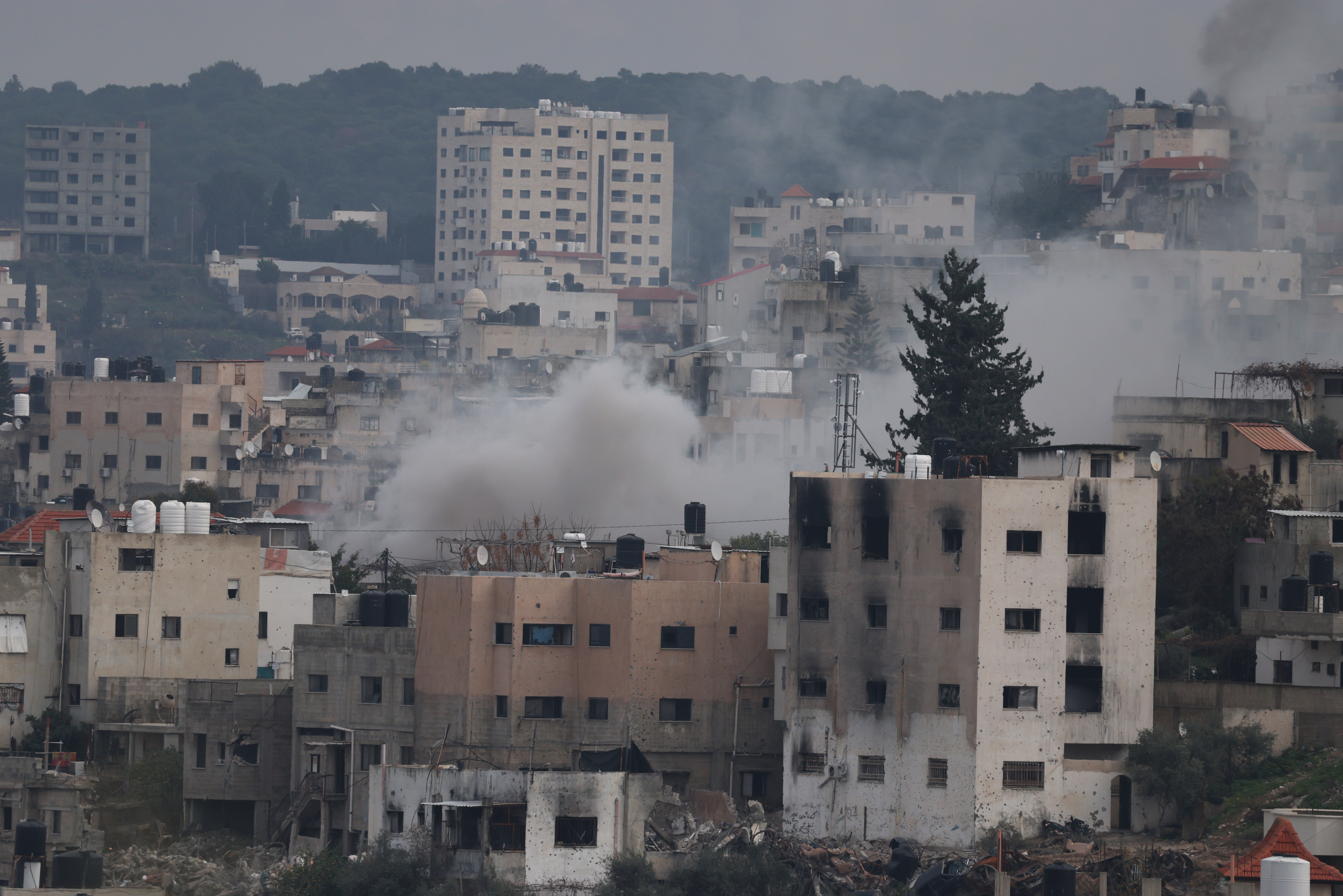 Smoke rises on the fourth day of an Israeli military operation in the West Bank city of Jenin on Friday 24 January 2025