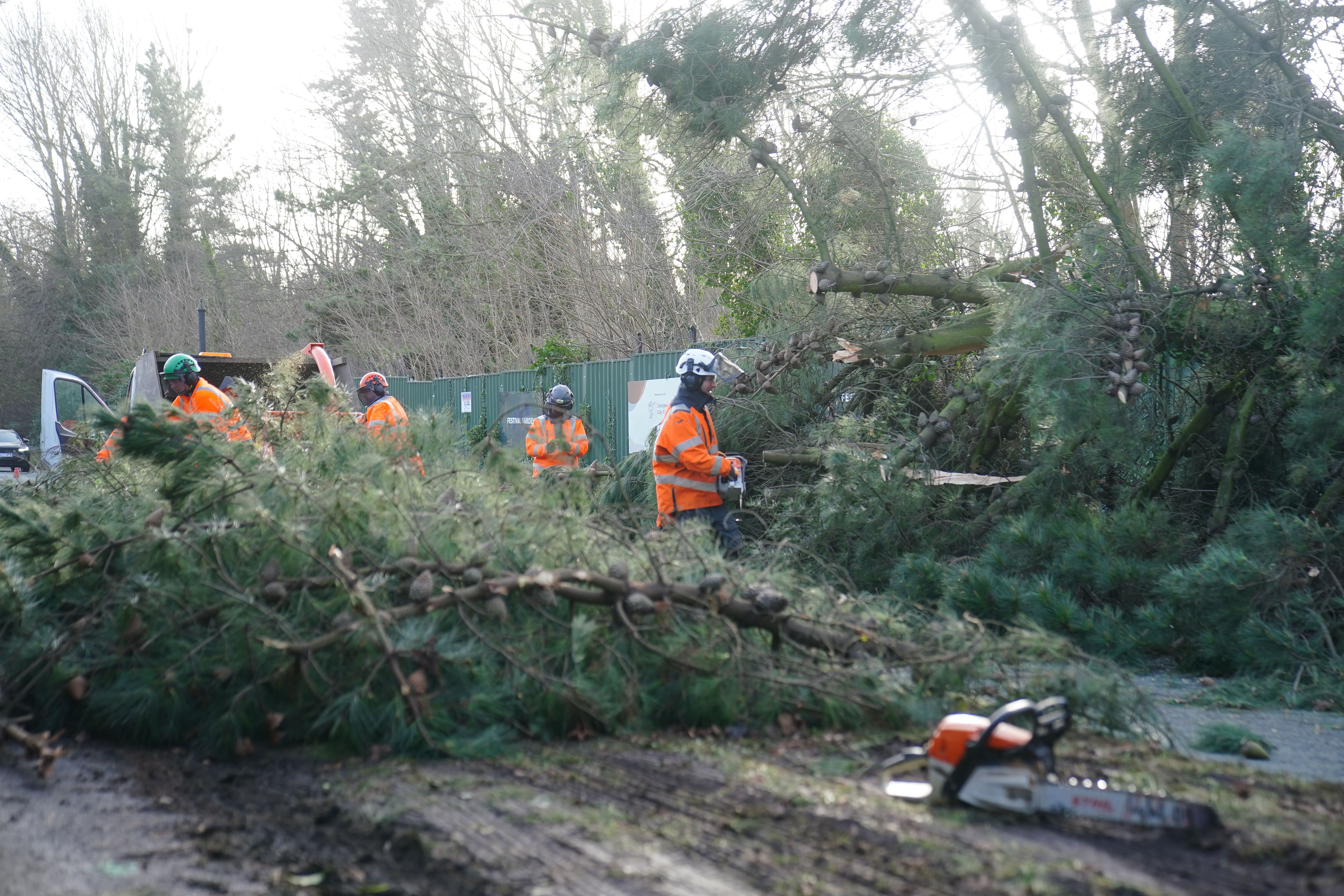 Tree surgeons remove a fallen tree in Liverpool (Peter Byrne/PA)