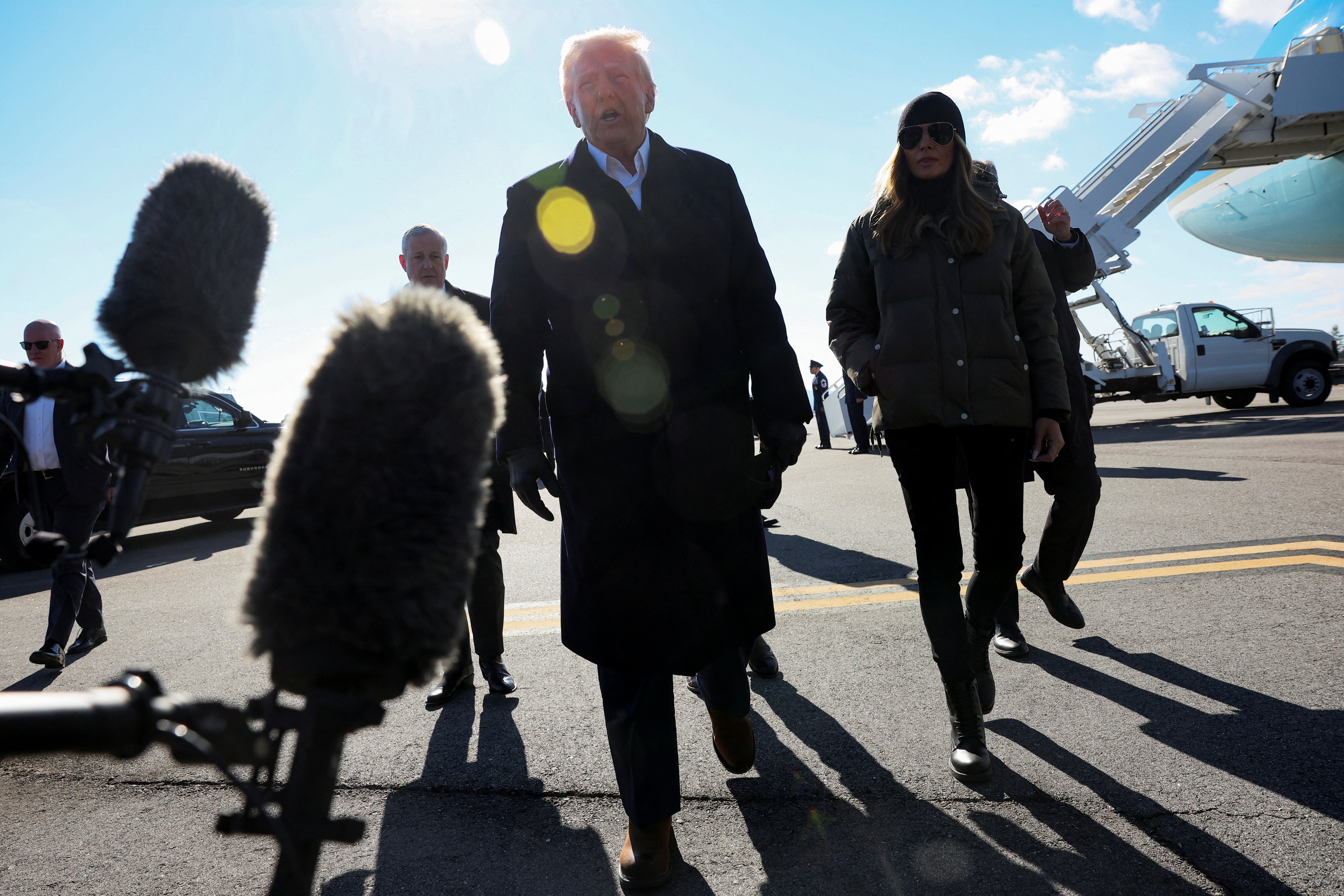 U.S. President Donald Trump speaks to the media next to first lady Melania Trump as he arrives to assess recovery efforts and tour areas devastated by Hurricane Helene in Asheville, North Carolina