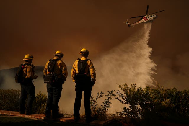 <p>Water is dropped by helicopter on the Palisades Fire in Mandeville Canyon, in Los Angeles earlier this month </p>