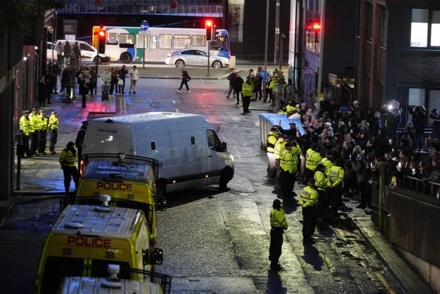 A prison van, watched by protesters, leaves Liverpool Crown Court, where Axel Rudakubana, 18, was detained for life with a minimum term of 52 years (Peter Byrne/PA)