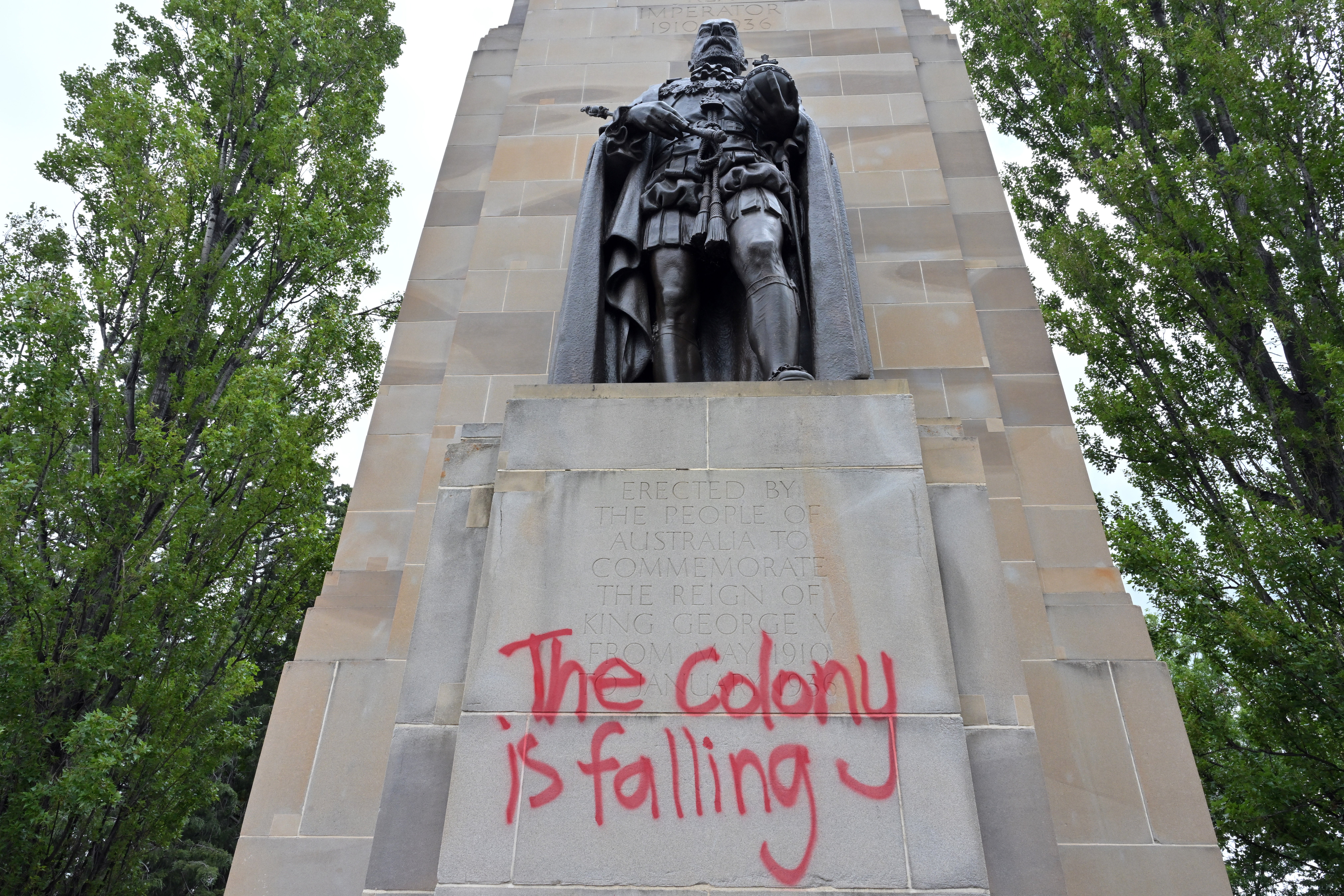 Graffitti is seen on England's King George V statue outside Old Parliament House during an Invasion Day rally in Canberra, Australia