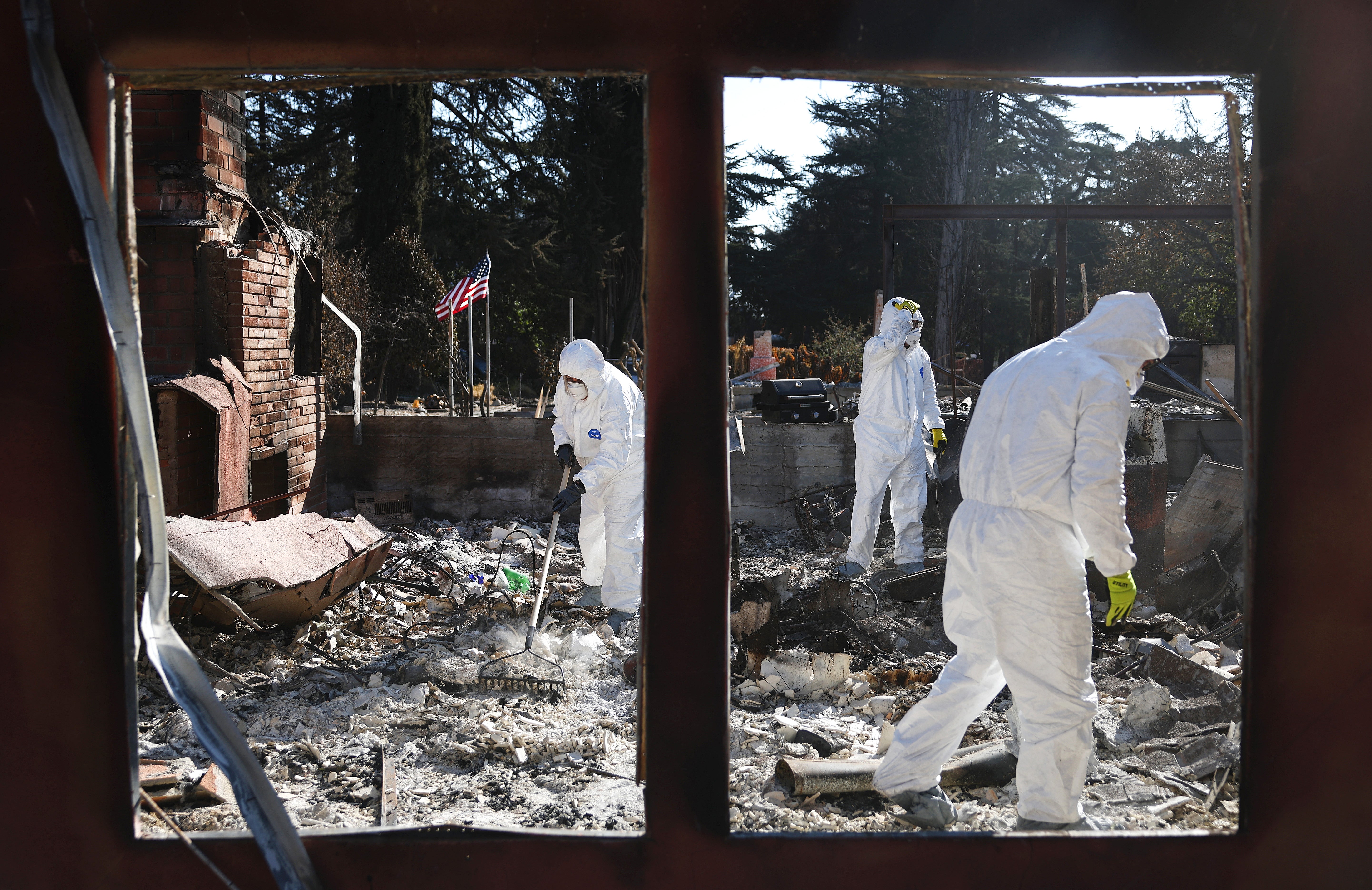 Nick Sonnenberg and his parents search for personal items to recover from the remains of his apartment which burned in the Eaton Fire on January 25 in Altadena, California