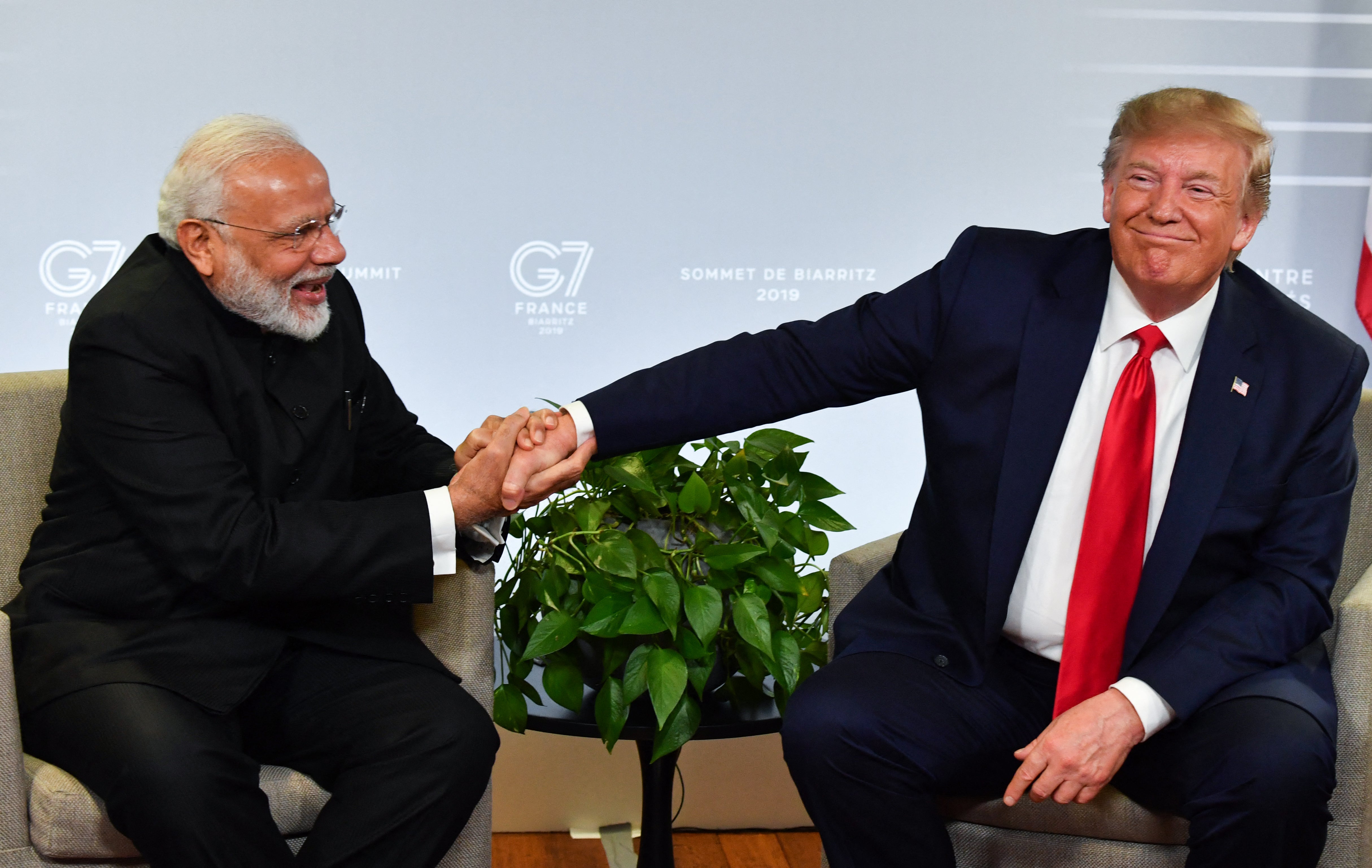 File. Narendra Modi and Donald Trump shake hands as they speak during a bilateral meeting in Biarritz, France