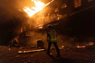 Firefighters extinguish a fire after a Russian attack on a civil factory in Kharkiv, Ukraine