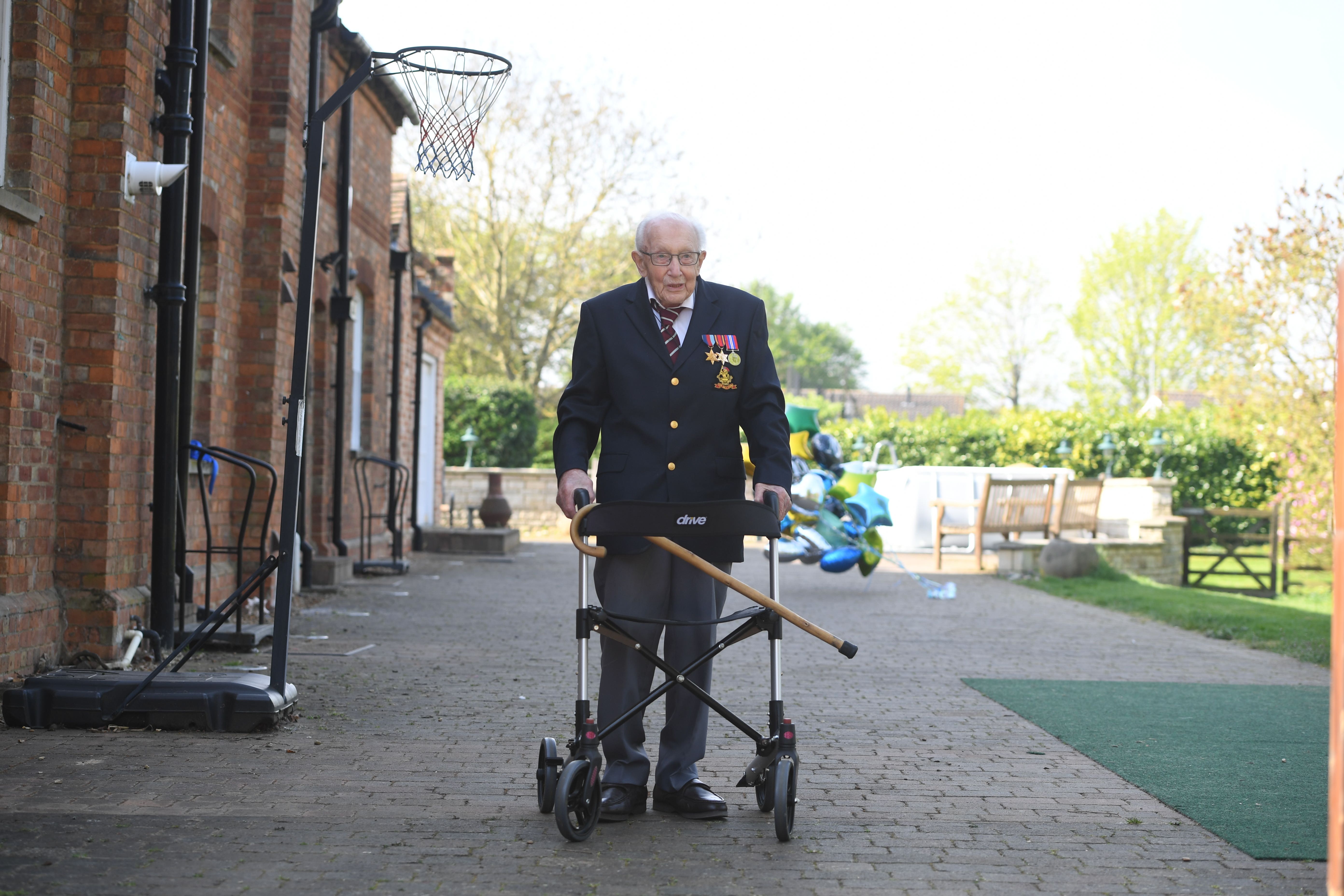Captain Sir Tom Moore pictured walking laps at his home in Marston Moretaine, Bedfordshire